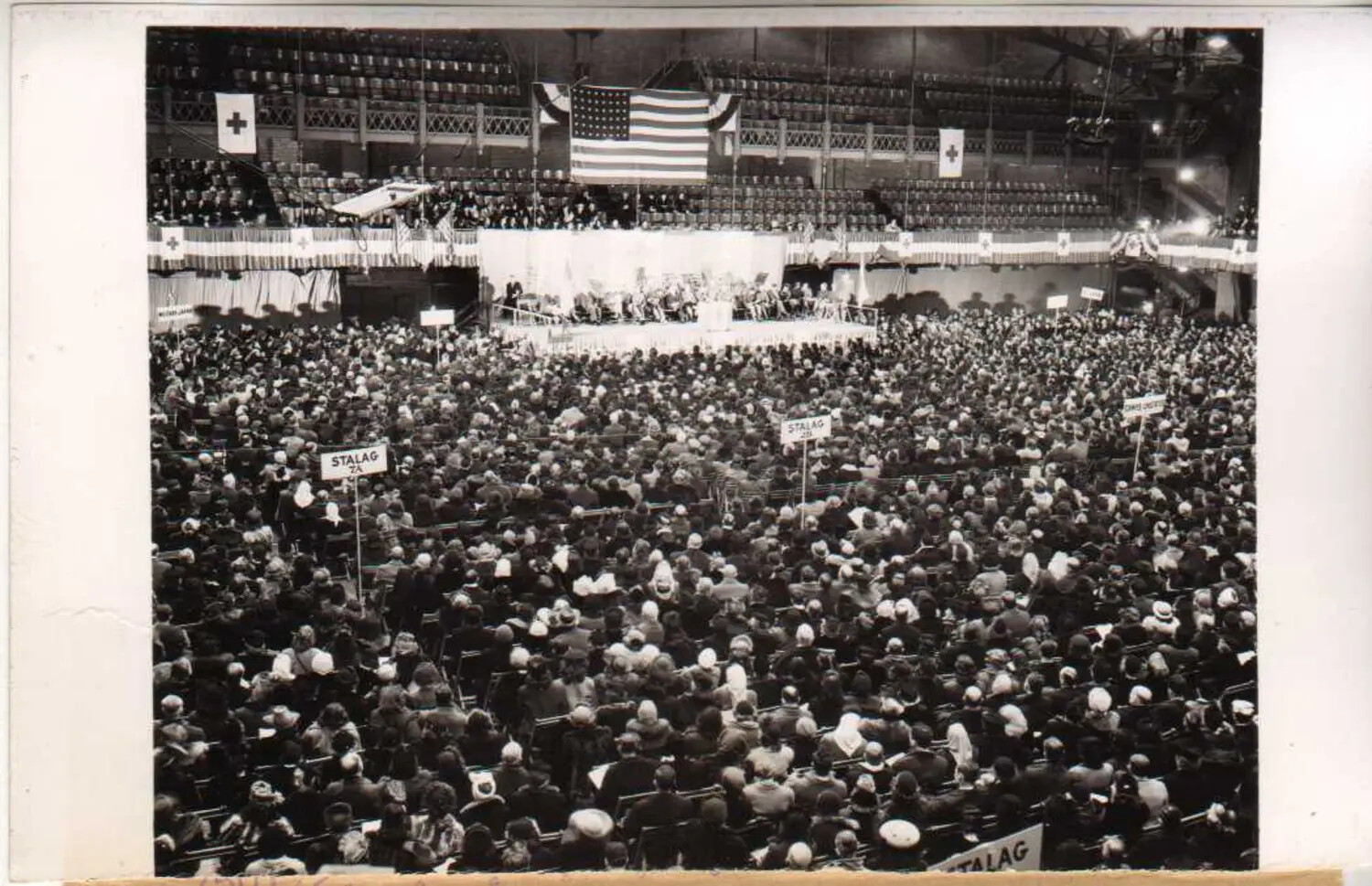 Mass Indoor Assembly with 'Stalag 7A' Section Markers, Likely WWII POW Reunion Event