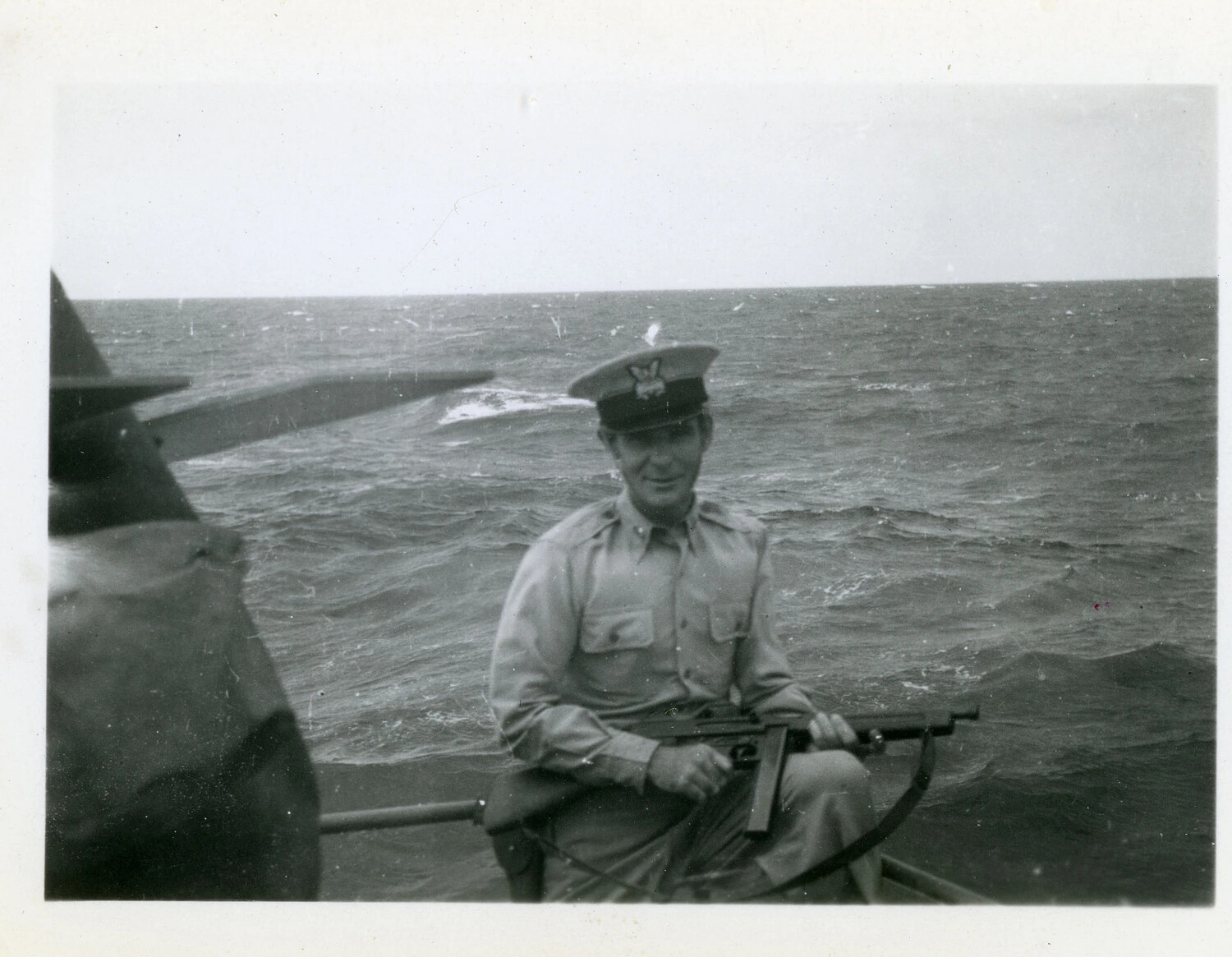 U.S. Navy Chief Petty Officer Seated on Deck with a Thompson Submachine Gun, Pacific Theater, World War II