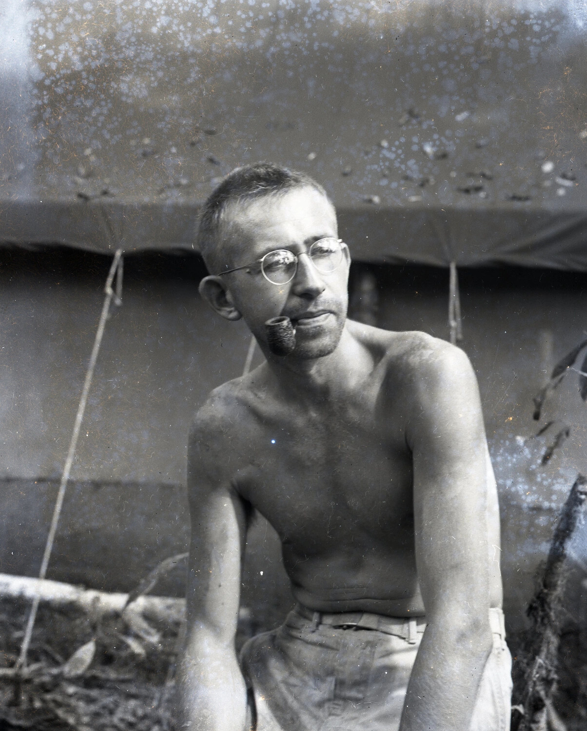 Portrait of a Shirtless Serviceman with Pipe at a CBI Theater Jungle Camp, World War II