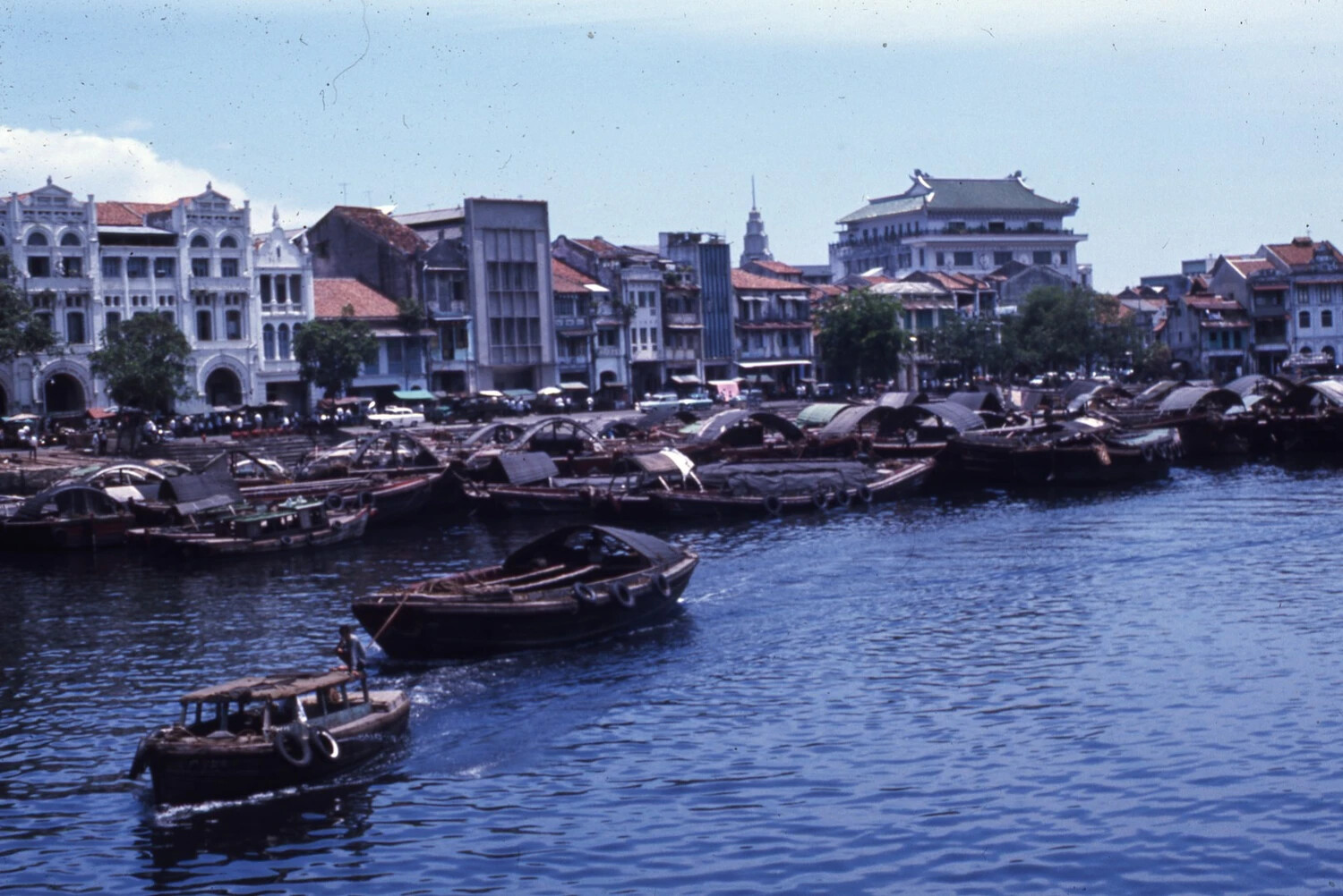 Riverside Colonial Shophouses and Cargo Boats, Likely Singapore, Vietnam War Era