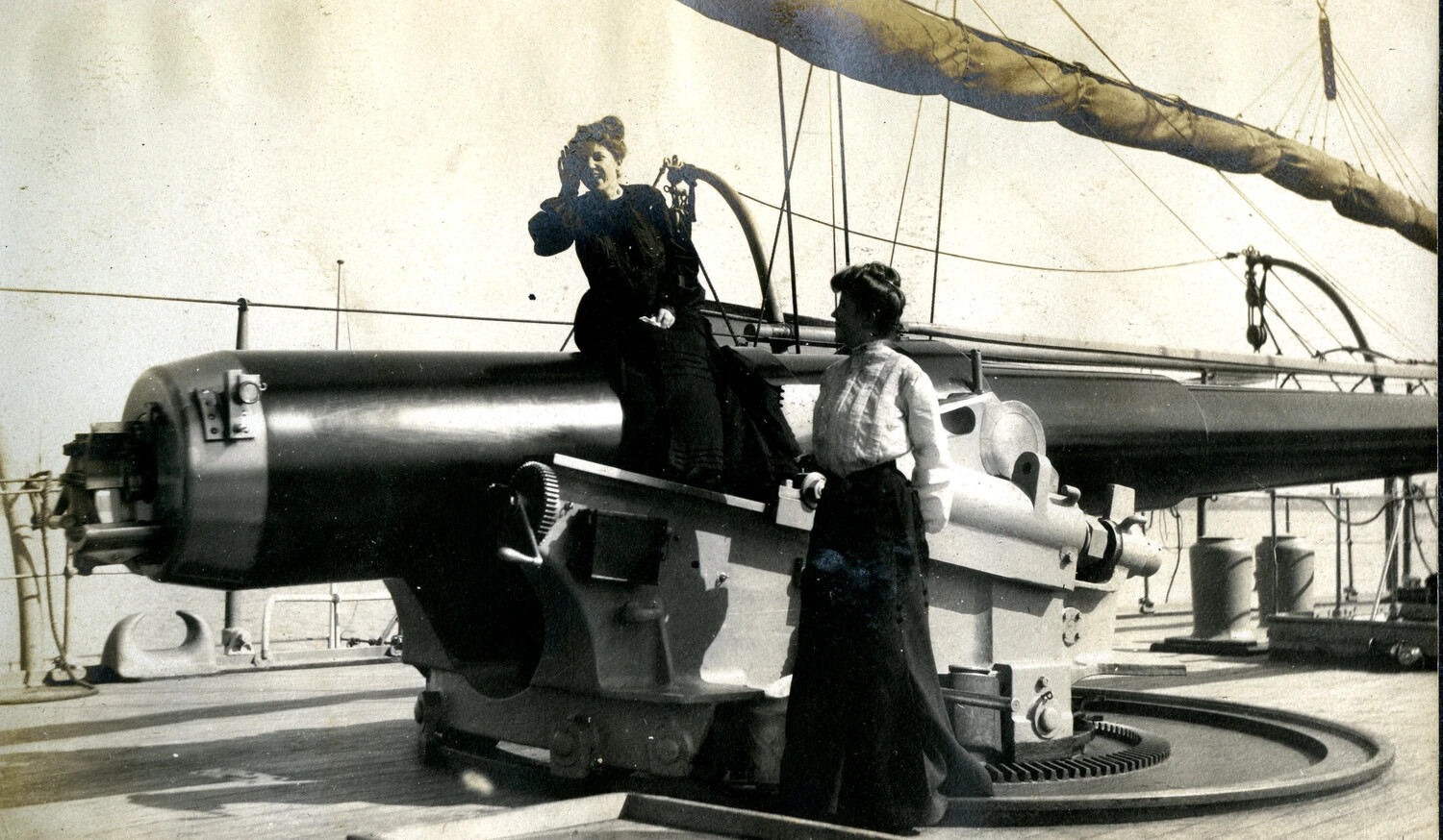 Civilian Women Posing on Ship's Deck Gun - 'Officers Visitors' (Detail) - USS Columbia Album