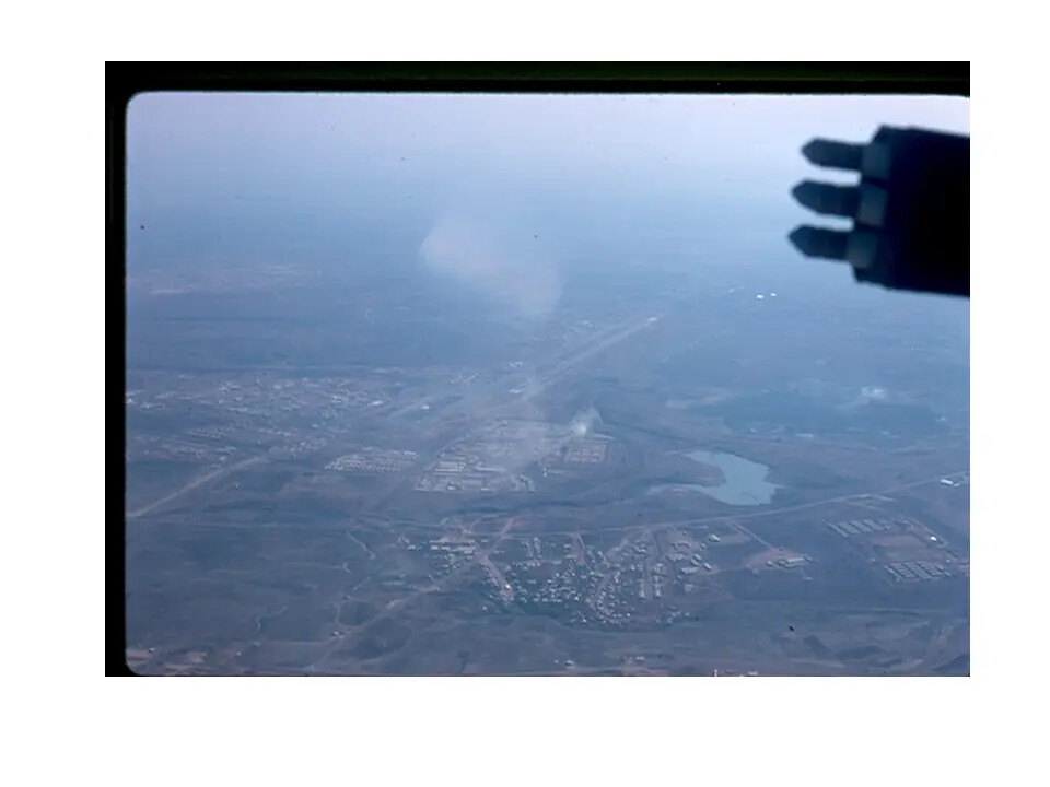 Aerial View of a Vietnam-Era Airbase from Cockpit, with Underwing Ordnance Visible