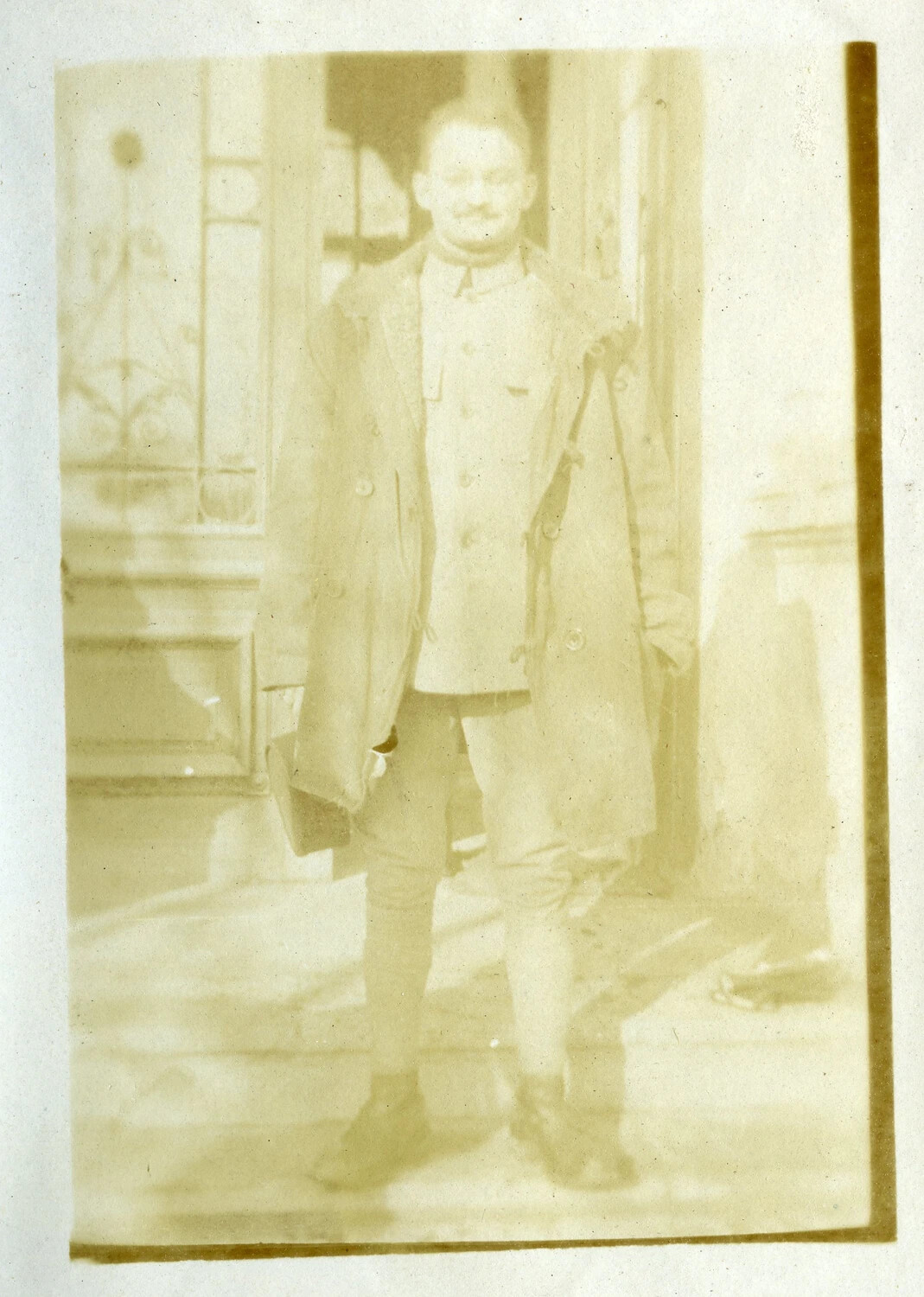 French Military Officer in Greatcoat at Doorway, WWI Era (French Pilot Album)