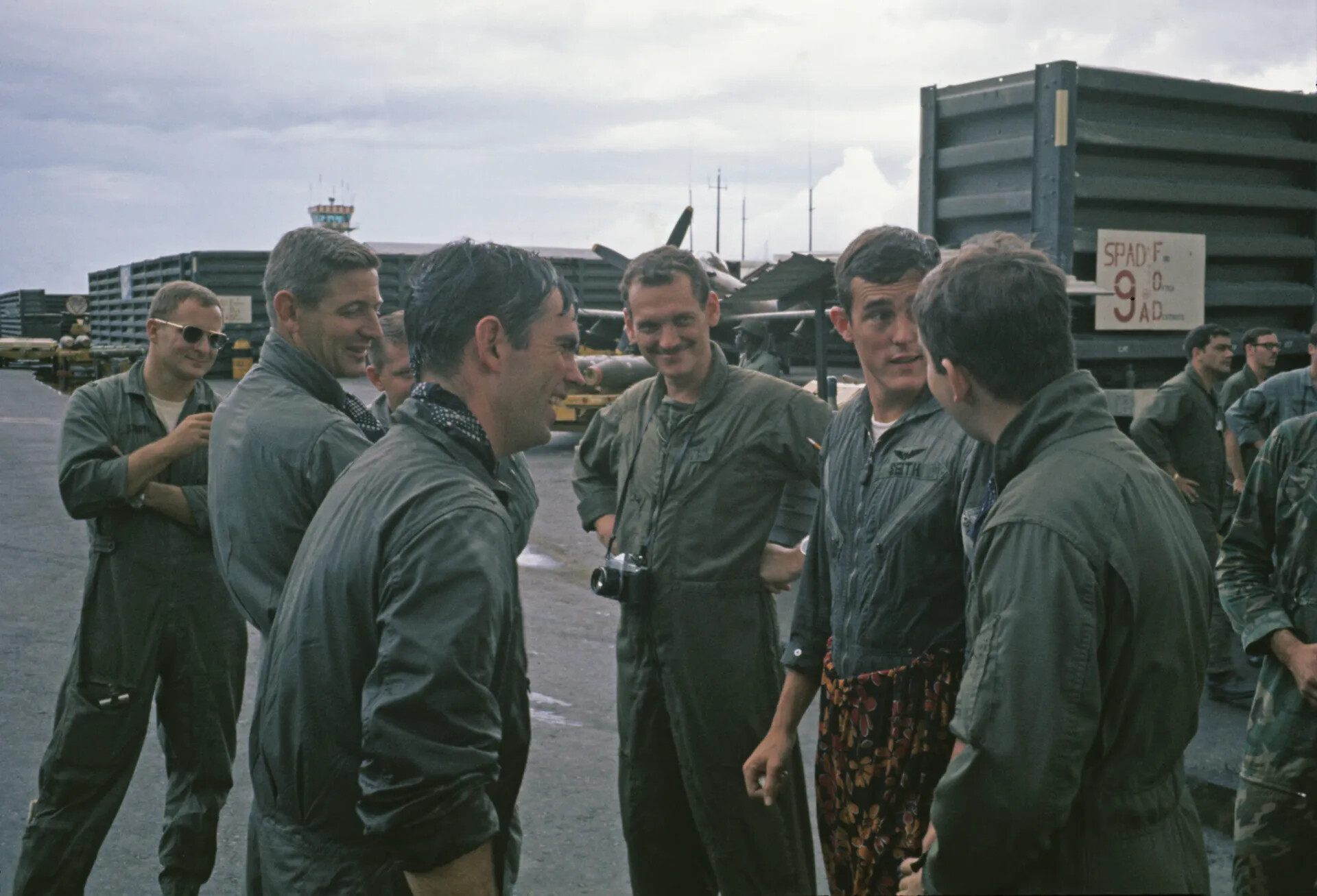 USAF Aircrew Gathering Near 'SPAD FOR 9 AD' Supply Crate, Named Pilot 'Seith,' Vietnam War Era