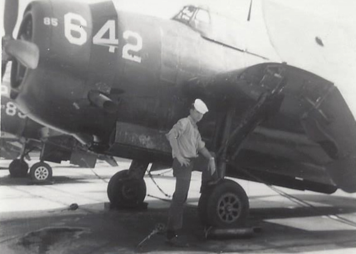 Sailor with Folded-Wing Navy Fighter Aircraft, NAS Jacksonville, Korean War Era