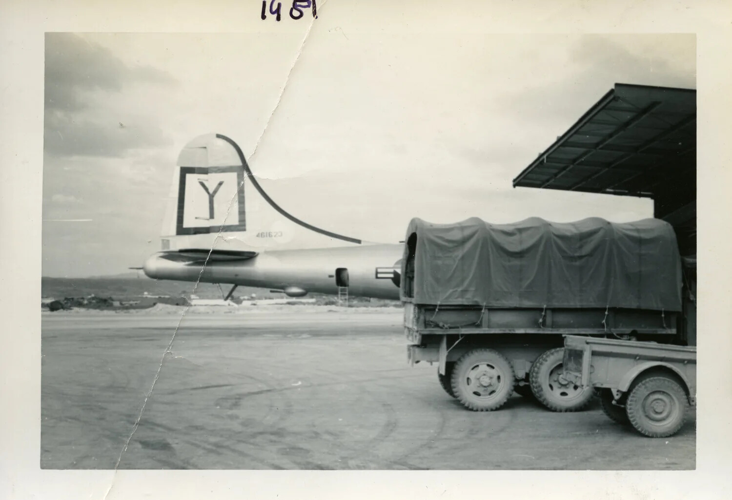 Boeing B-29 Superfortress Tail Section on Flight Line with Cargo Truck and Trailer, Korean War Era