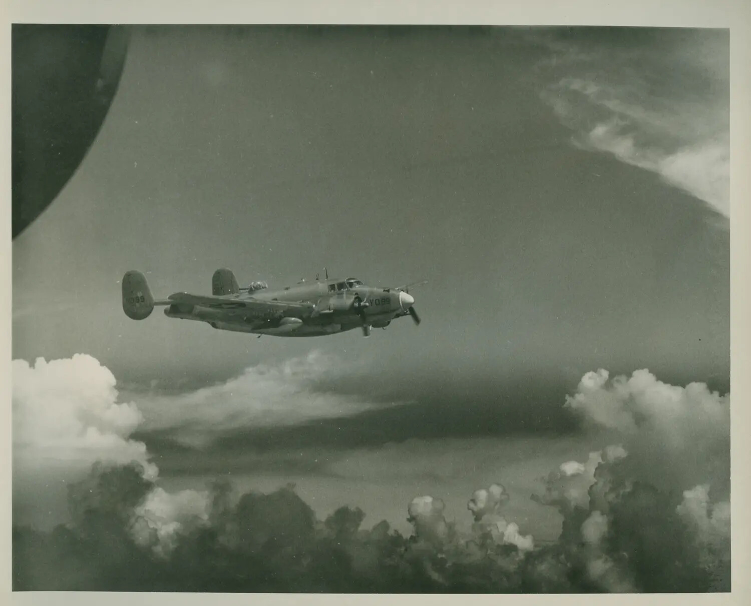 Twin-Engine Military Utility Aircraft in Flight Above Clouds, USS Petrof Bay (CVE-80) Collection