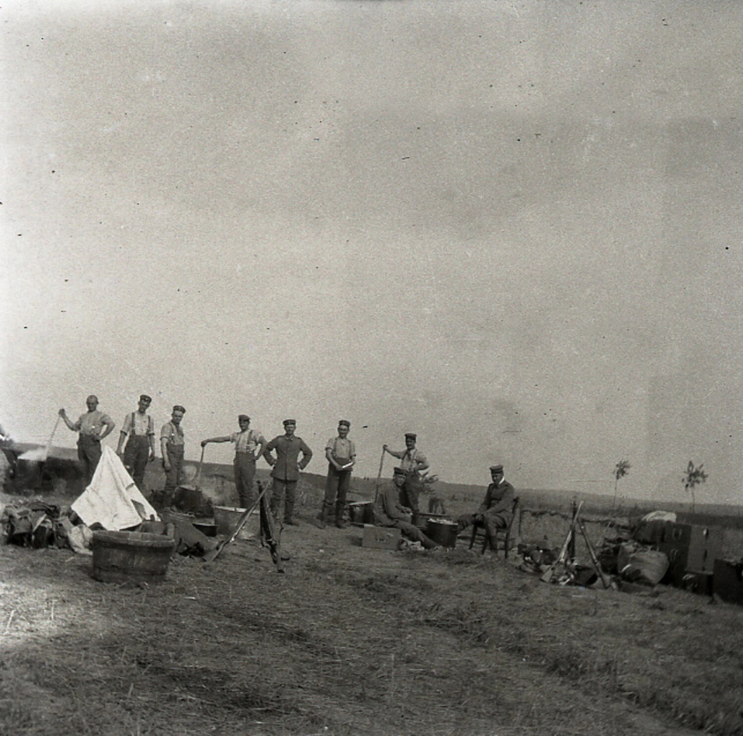German Soldiers at Field Camp with Cooking Pots and Stacked Rifles, WWI