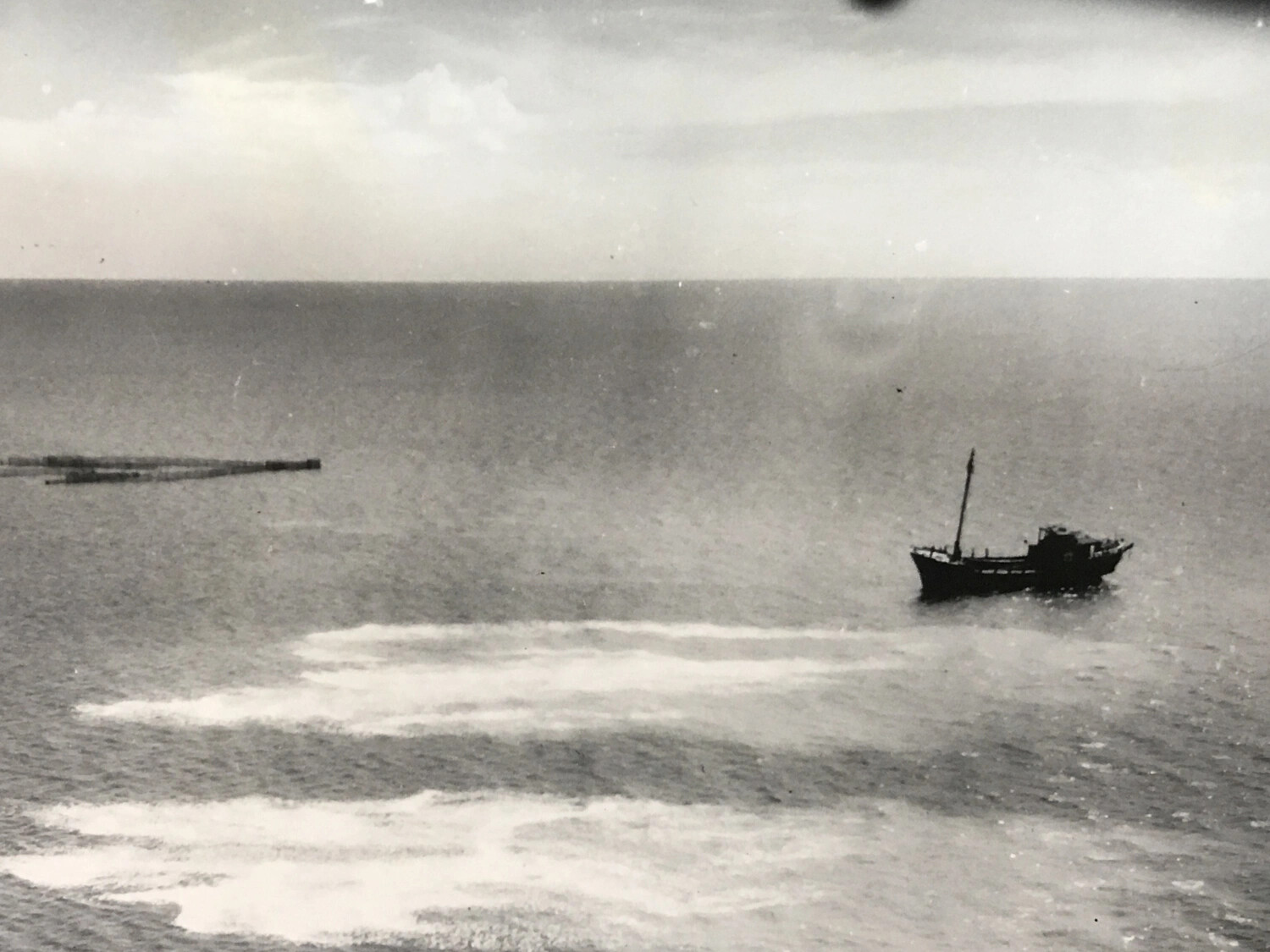 Aerial Attack Photograph: Small Vessel Under Strafing Fire at Sea, Pacific Theater, WWII