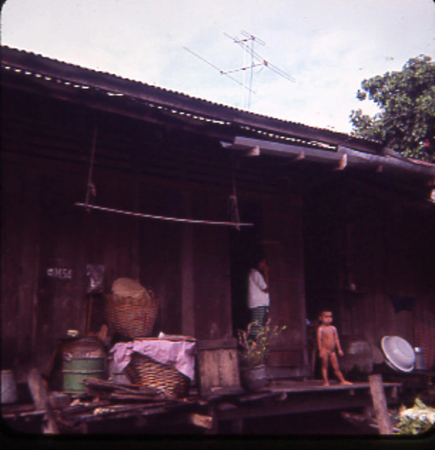 Rural Stilt House with Family, Vietnam, Vietnam War Era