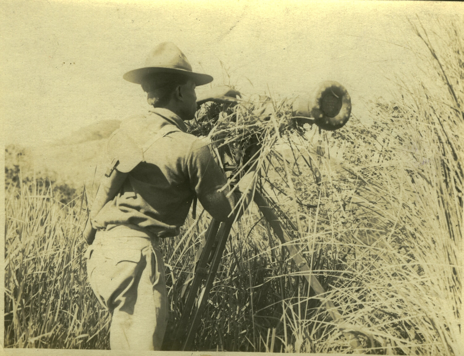 Soldier with Tripod-Mounted Signaling or Observation Instrument in Tall Grass, Philippines, Early 1900s