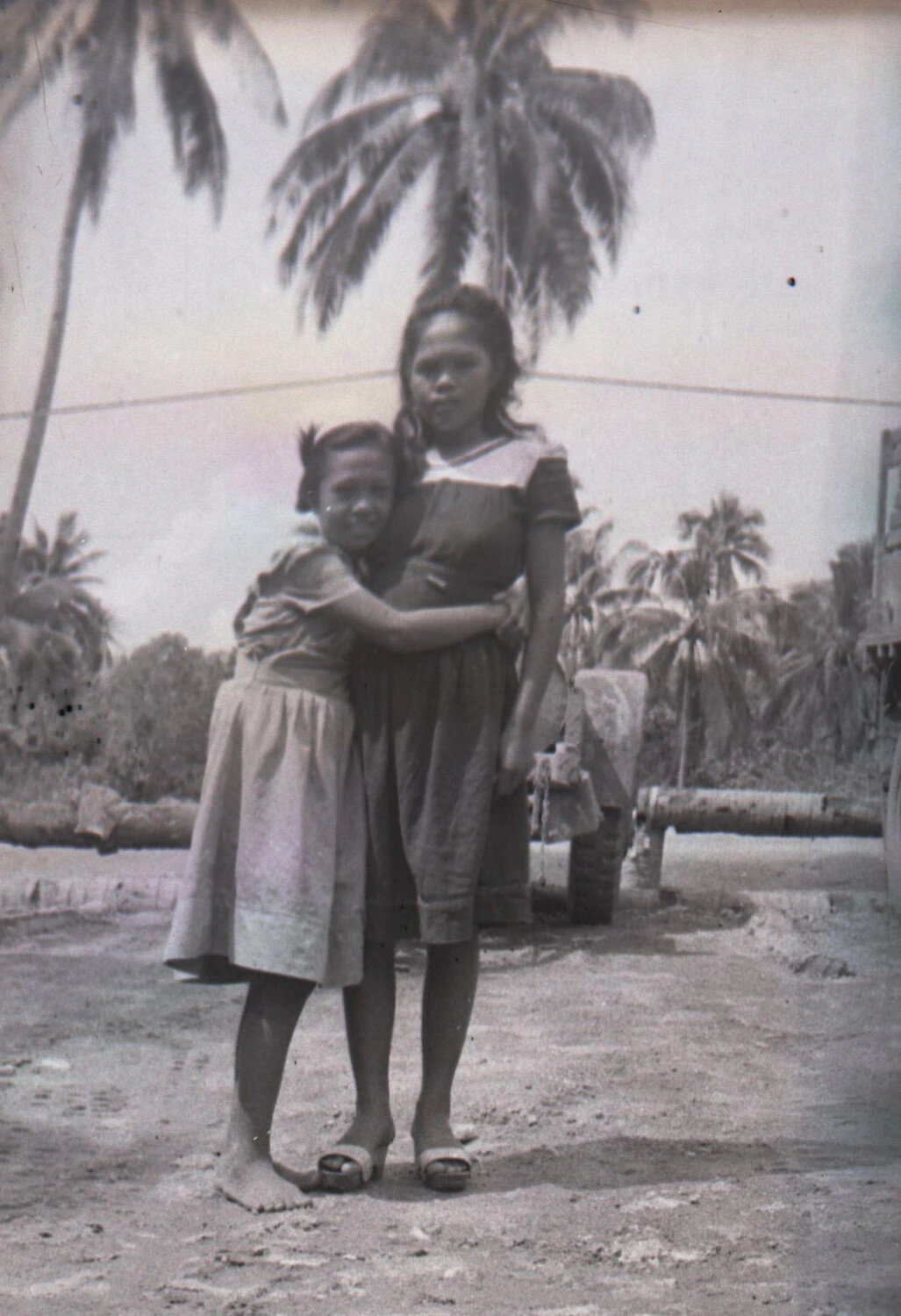 Two Filipino Sisters/Family Members Embracing Under Palm Trees, Luzon, Philippines, WWII Era
