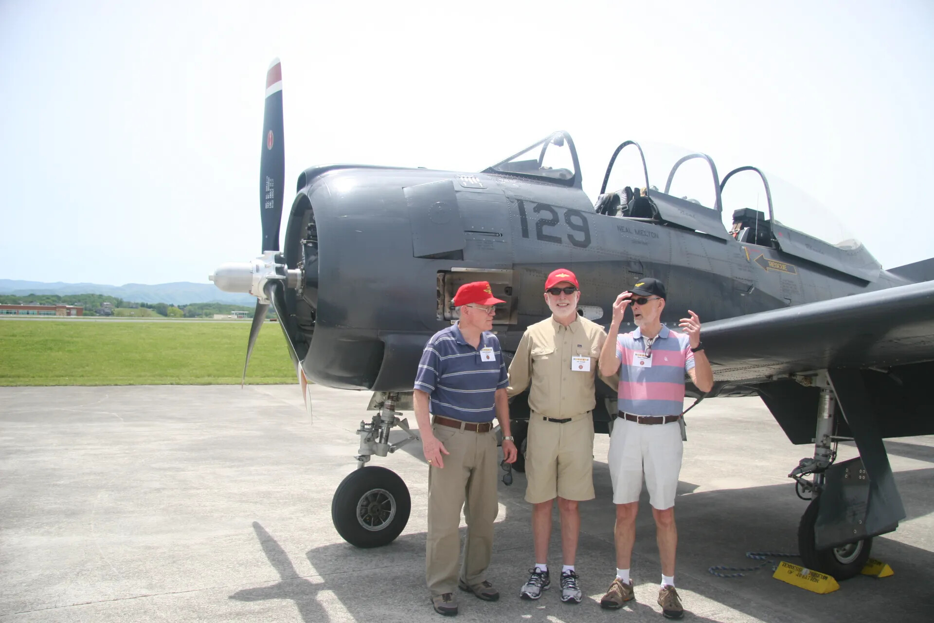 Veterans Conversing in Front of Preserved A-1 Skyraider-Type Aircraft 'Neal Melton' (No. 129), Tennessee Museum of Aviation Reunion Event, April 2016