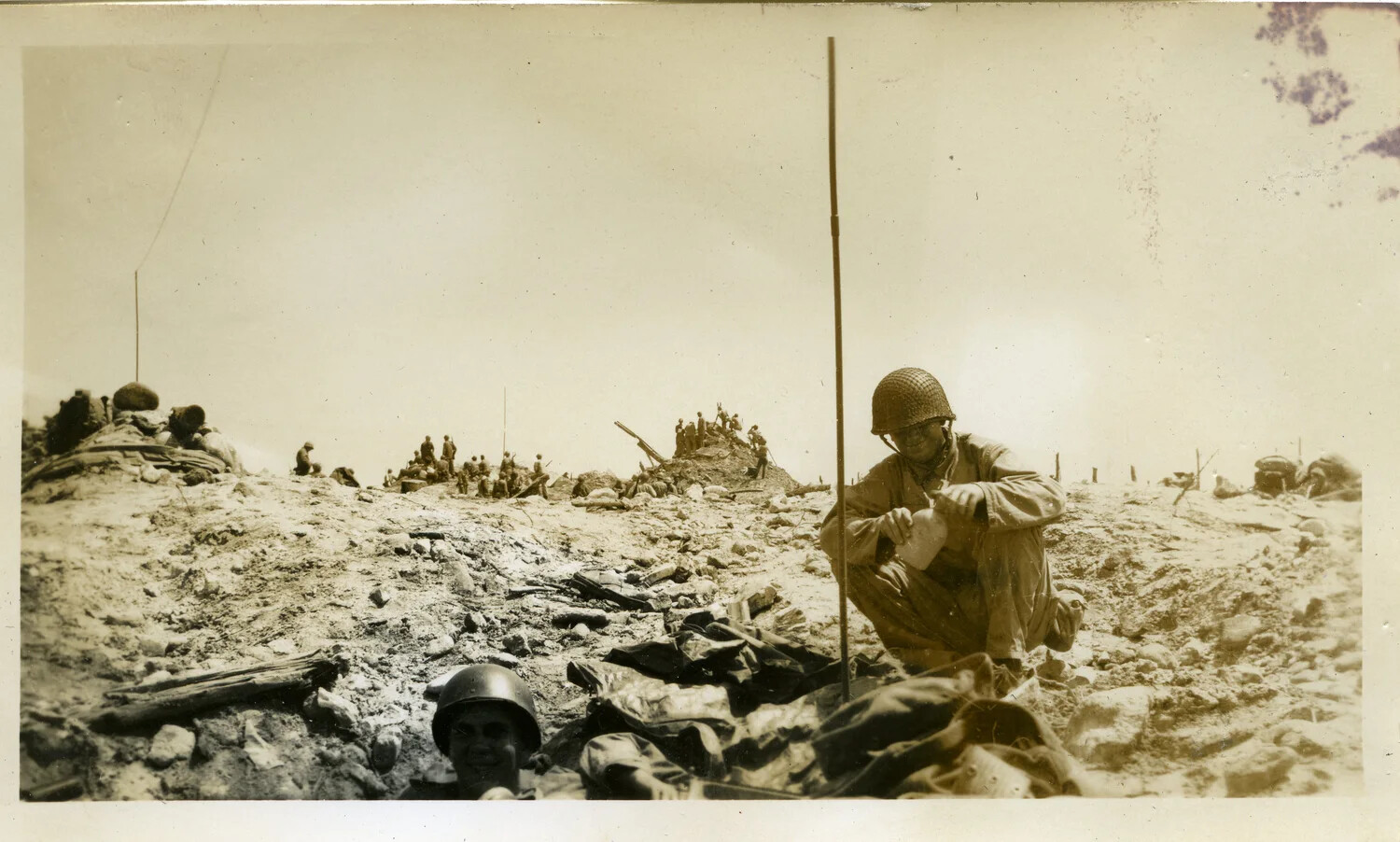 U.S. Troops in Foxholes Amid Bombardment Debris, Kwajalein Atoll, World War II