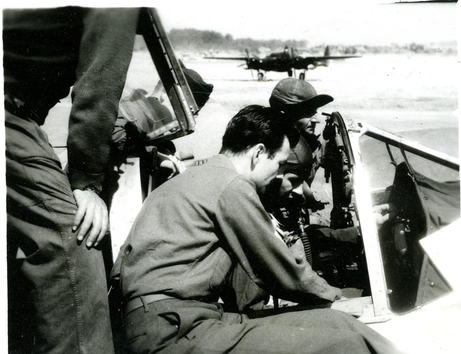 Ground Crew at Fighter Cockpit with Twin-Engine Aircraft in Background, Burma Campaign Collection