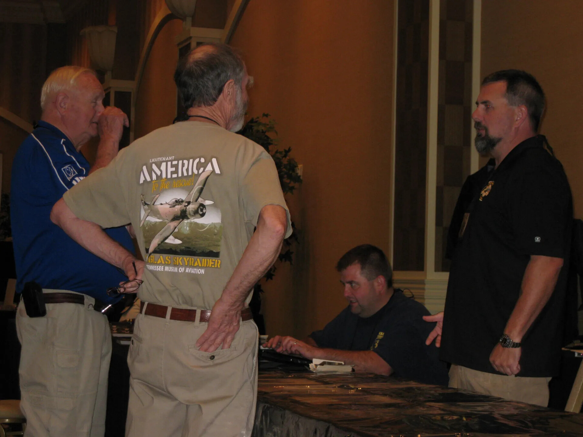 Attendees at the Counter, with Douglas A-1 Skyraider Shirt in Full View, SOAR XXXVII, Las Vegas, 2013