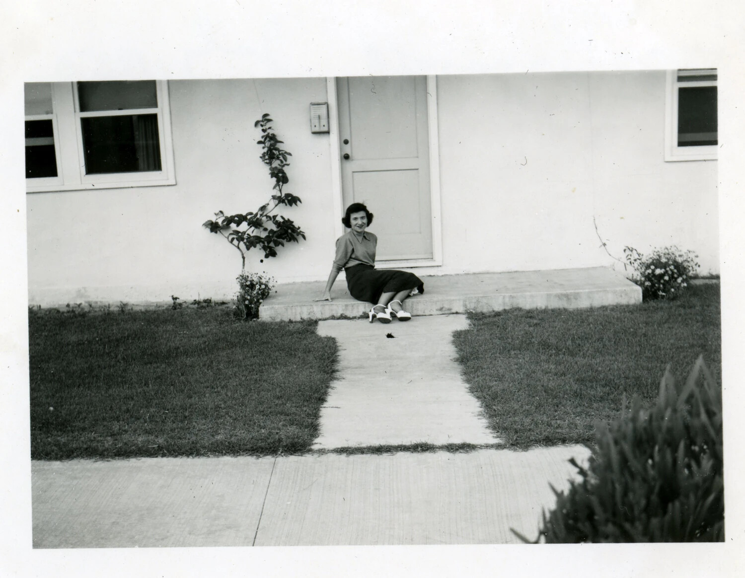 Woman Seated on Front Step, Pensacola, Florida, April 1949 - Lt. Bancroft Collection