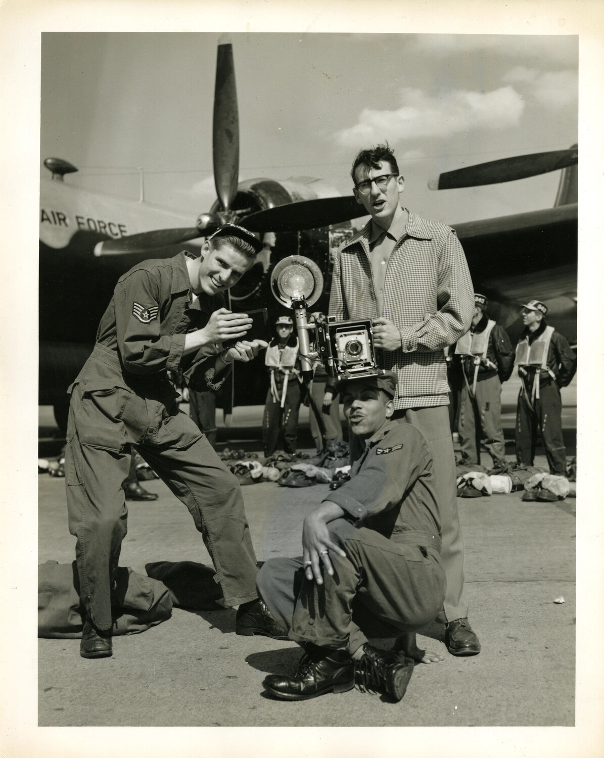 U.S. Air Force Publicity Photograph: Airmen Clowning for Press Photographer on Flight Line