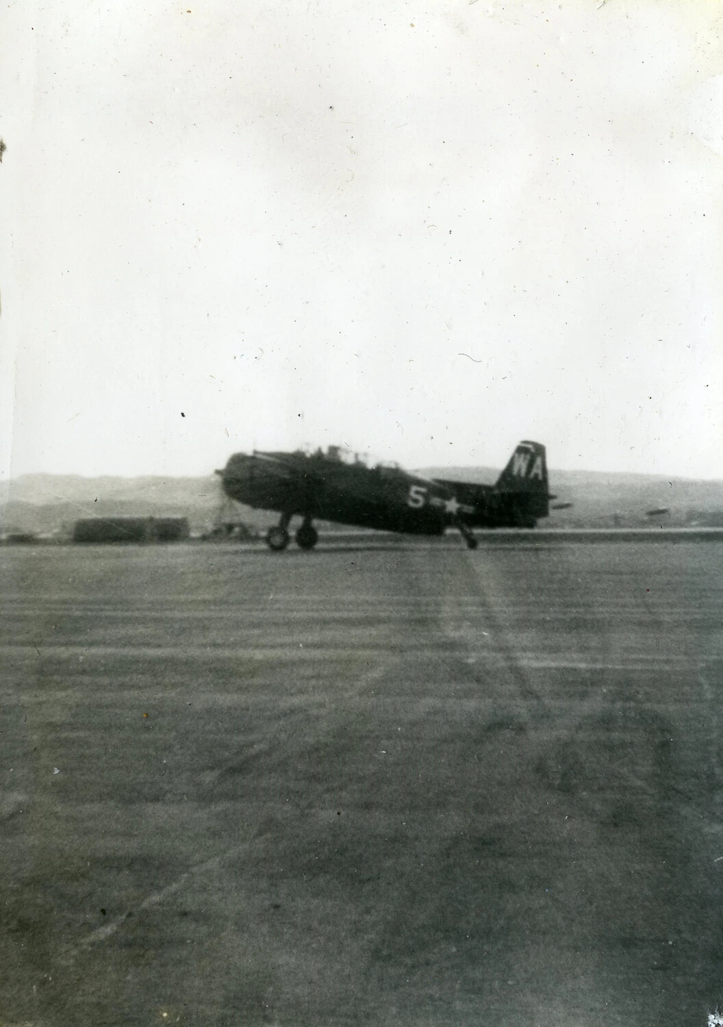 Single-Engine U.S. Navy/Marine Aircraft on Airfield Tarmac, Tail Code 'WA', No. 5 — 1945