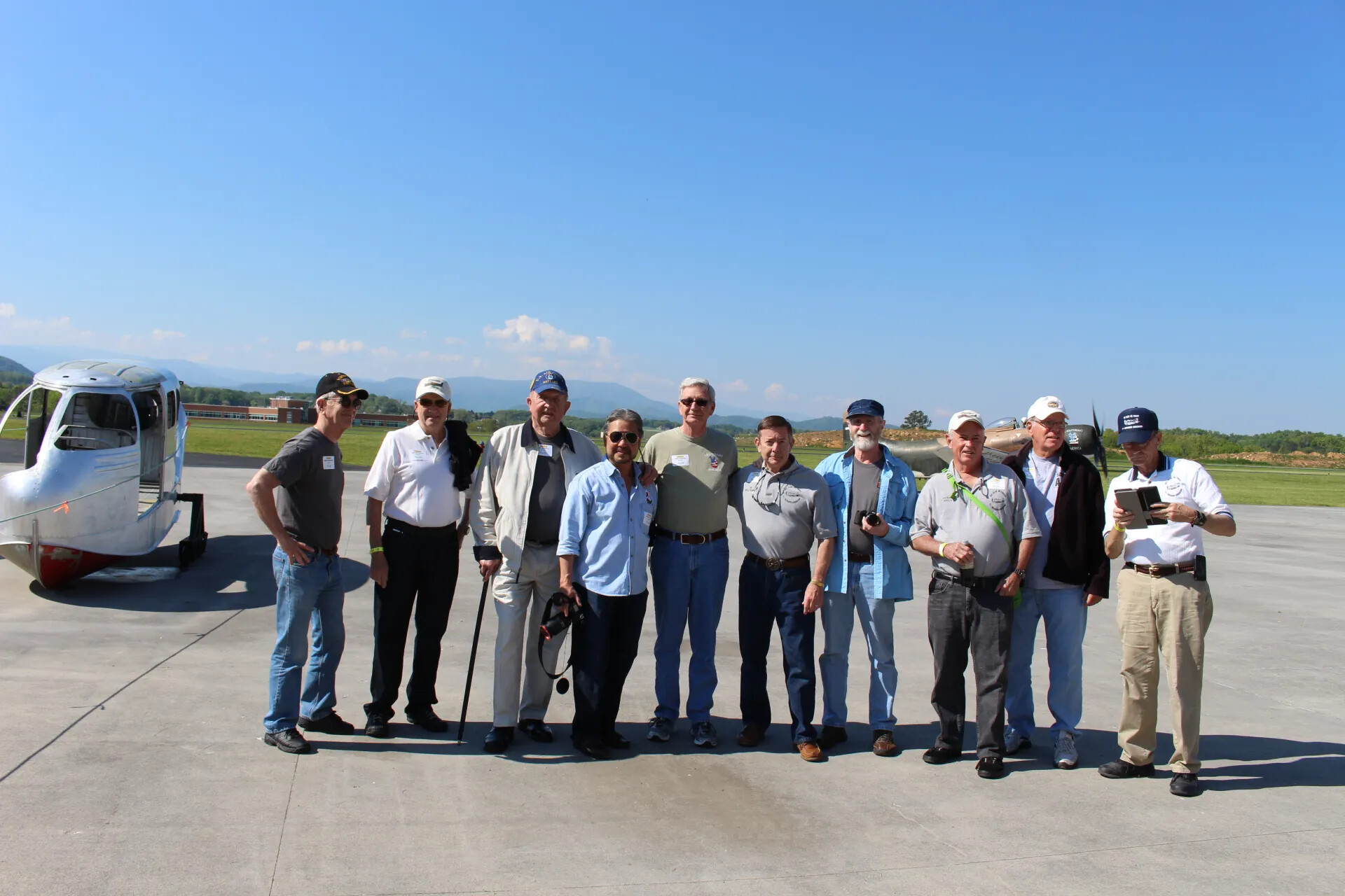 Veterans Reunion Group Portrait with Vintage Amphibious Aircraft Nose Section, Air Museum Tarmac