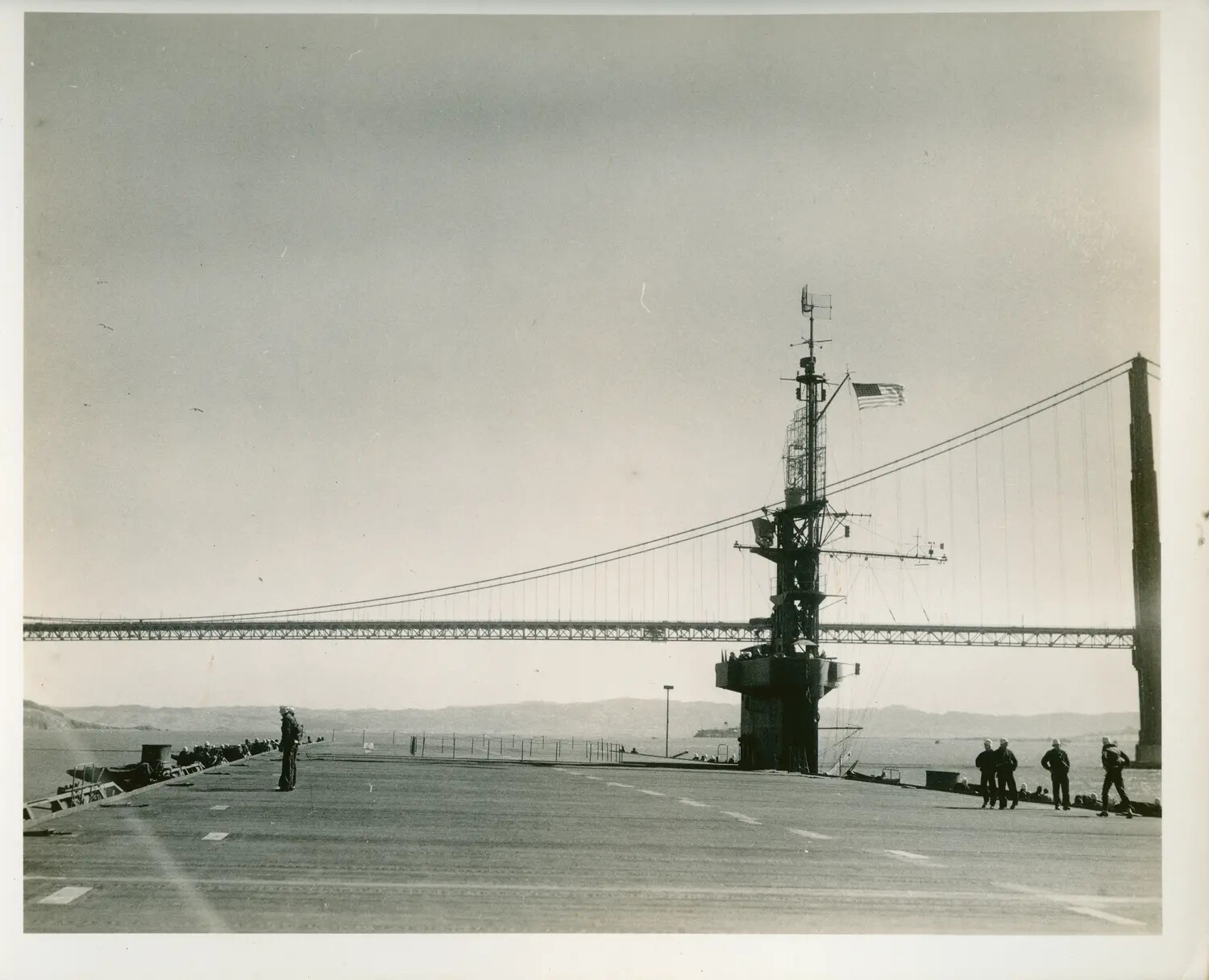 USS Petrof Bay (CVE-80) Flight Deck with Sailors Manning the Rail, Passing Beneath the Golden Gate Bridge