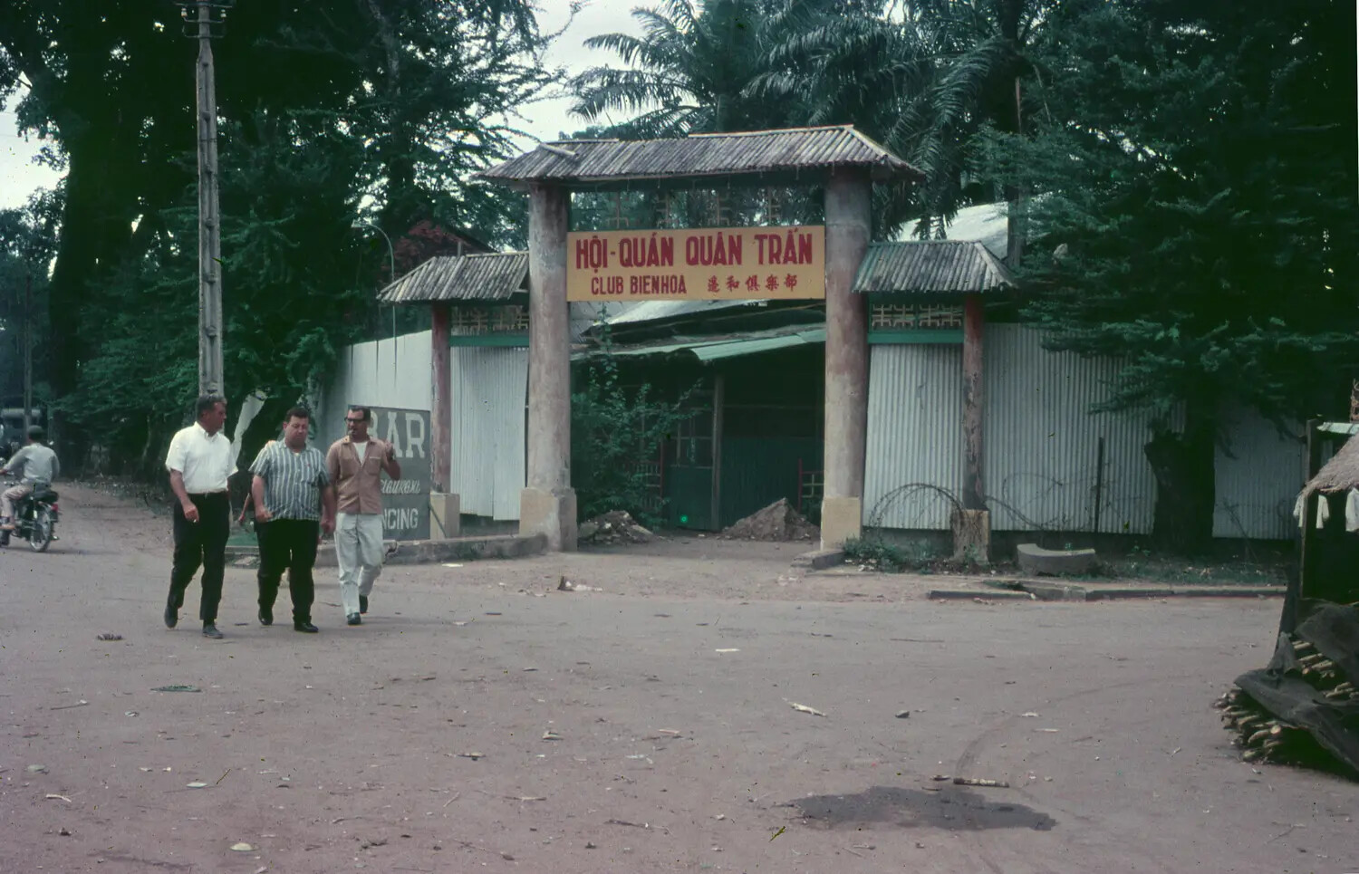 Three Men Outside Club Bienhoa Entrance Gate, Bien Hoa, South Vietnam, 1965