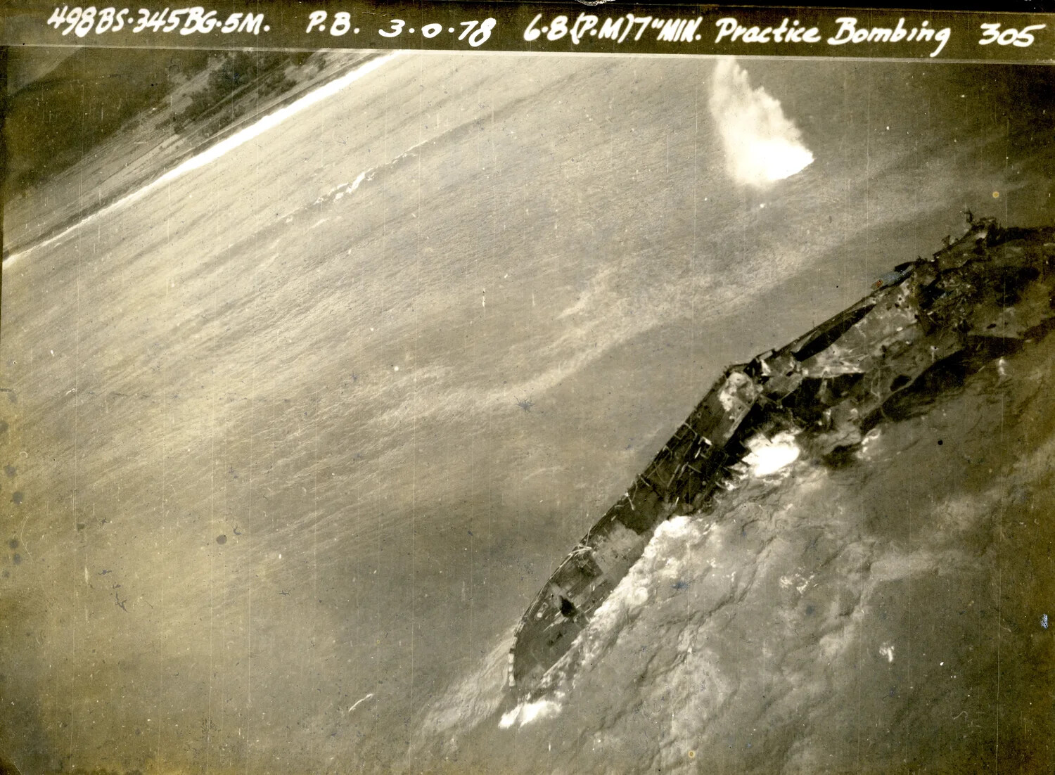 345th Bombardment Group Practice Bombing Run on Shipwreck Target Hulk (Wide Miss)