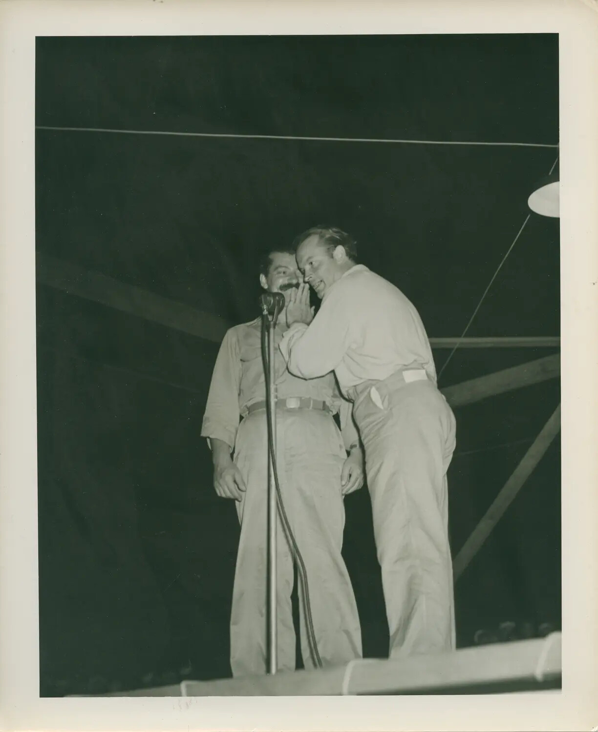 Sailors Performing a Comedy Skit at Microphone, USS Petrof Bay (CVE-80) Hangar Deck, WWII