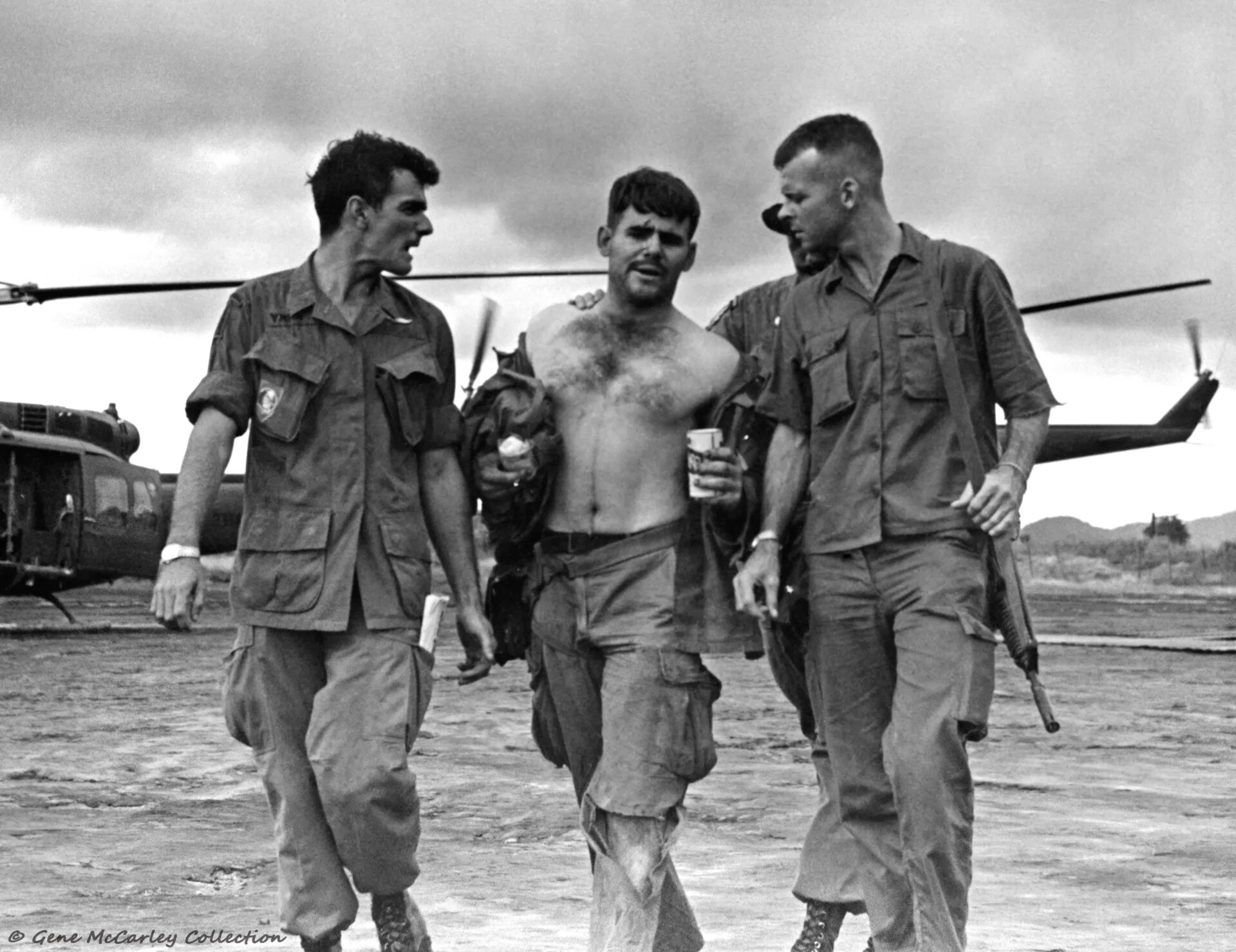 Exhausted Soldier Assisted Across Airstrip After Field Operation, Vietnam