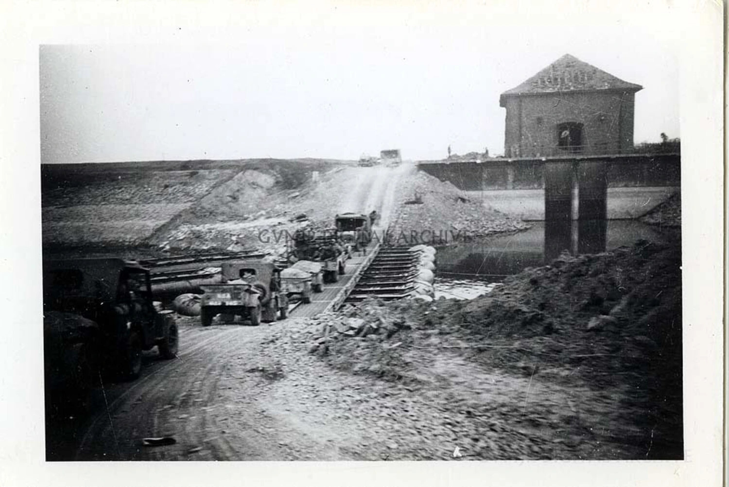 U.S. Army Vehicle Convoy Crossing a Repaired Canal Bridge, European Theater, 1944
