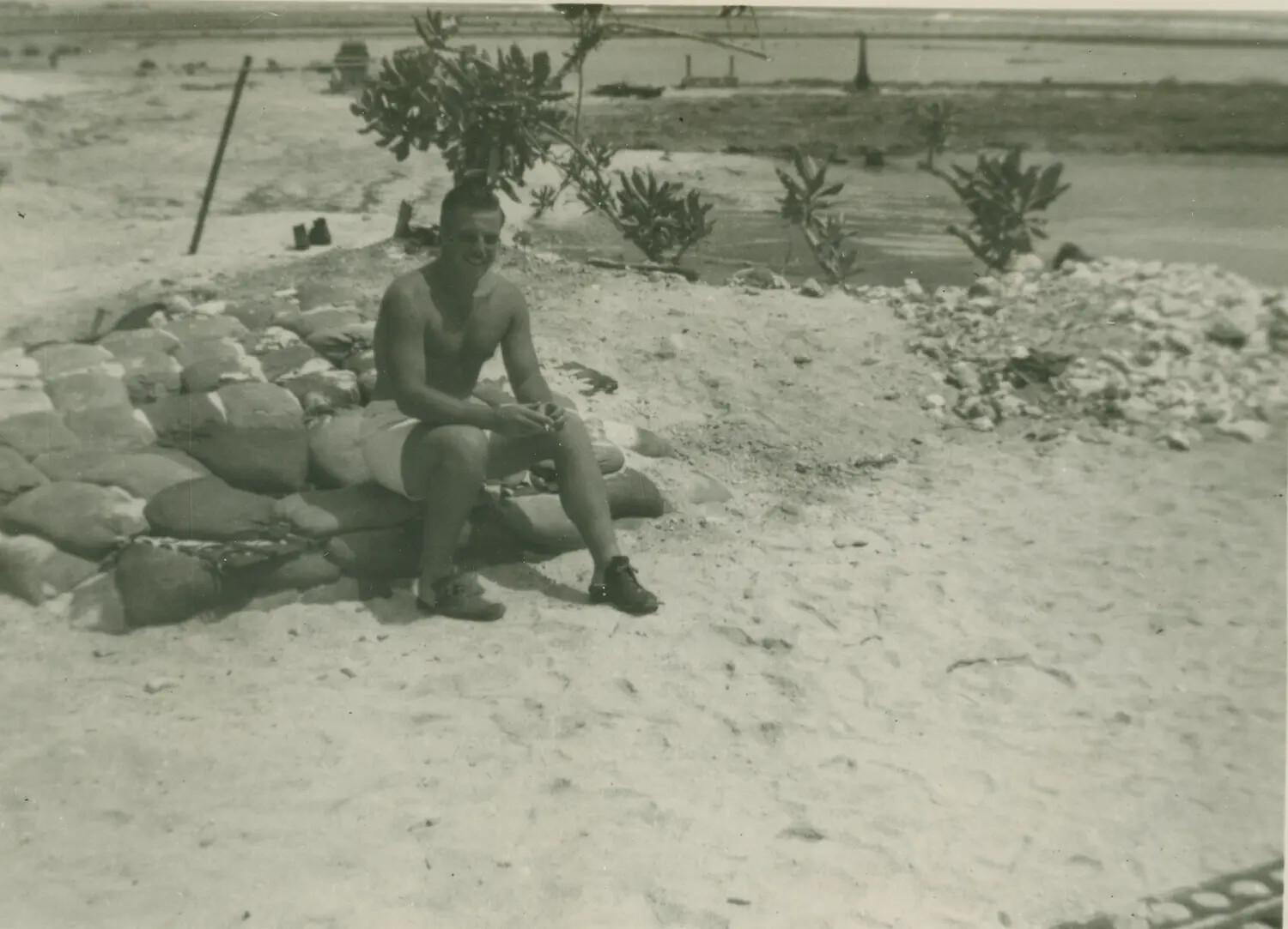 Serviceman Relaxing on Sandbag Revetment, Pacific Atoll, WWII