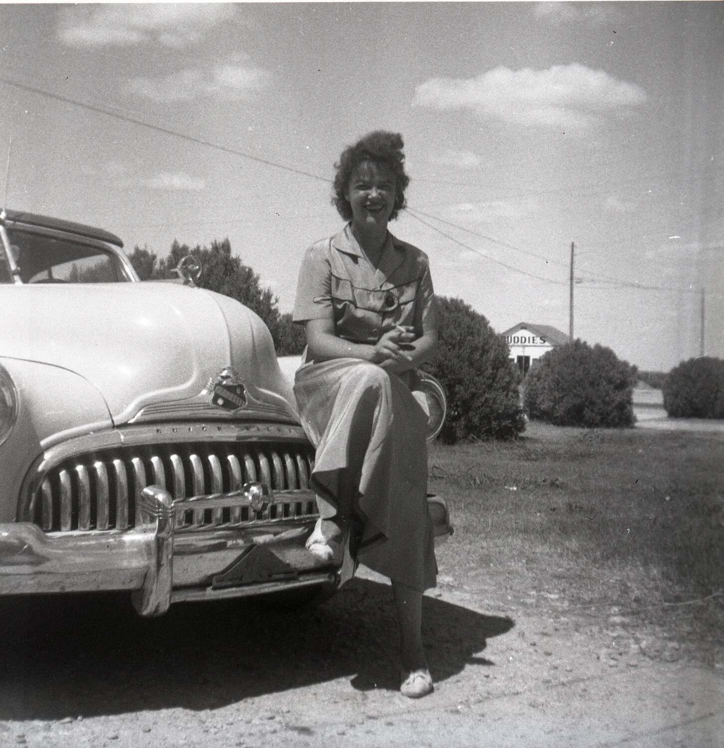 Woman Posed on the Front Fender of a Buick Sedan Along a Rural Roadside