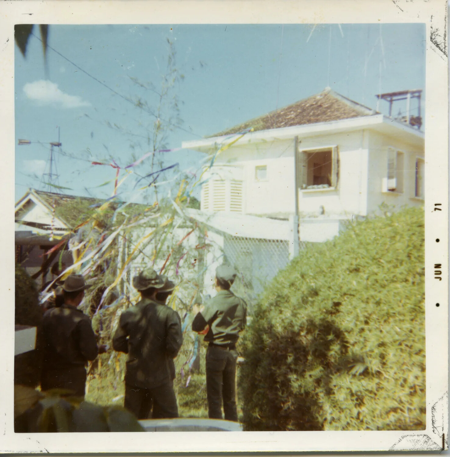 Servicemen Viewing a Streamer-Decorated Tree Near Base Building, Vietnam, 1971