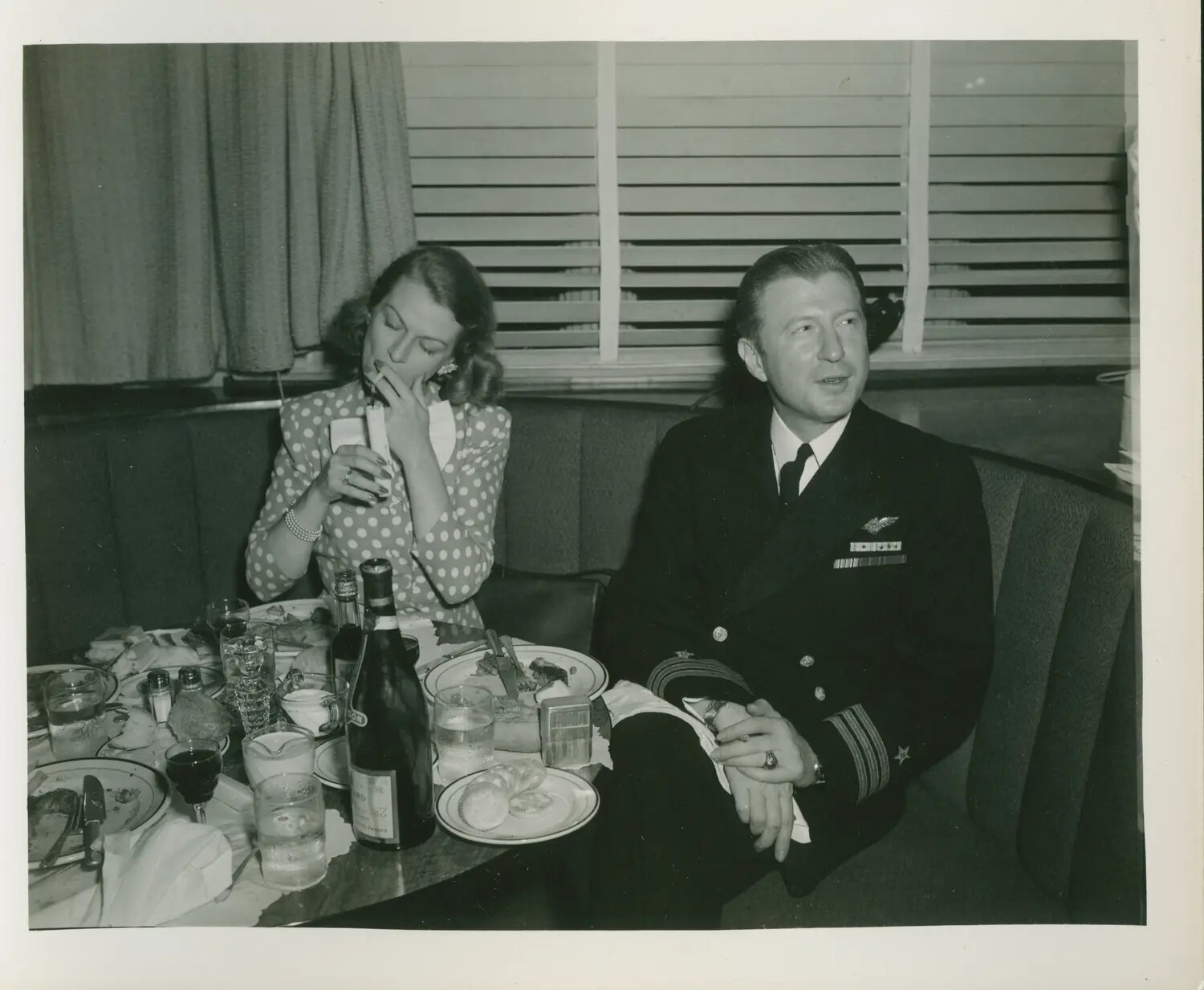 U.S. Navy Officer with Naval Aviator Wings and Companion at Dinner, WWII Era (USS Petrof Bay Collection)