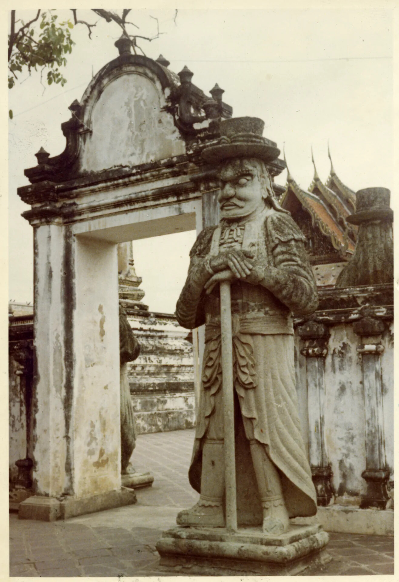 Weathered Gateway and Stone Guardian Statue, Bangkok Temple