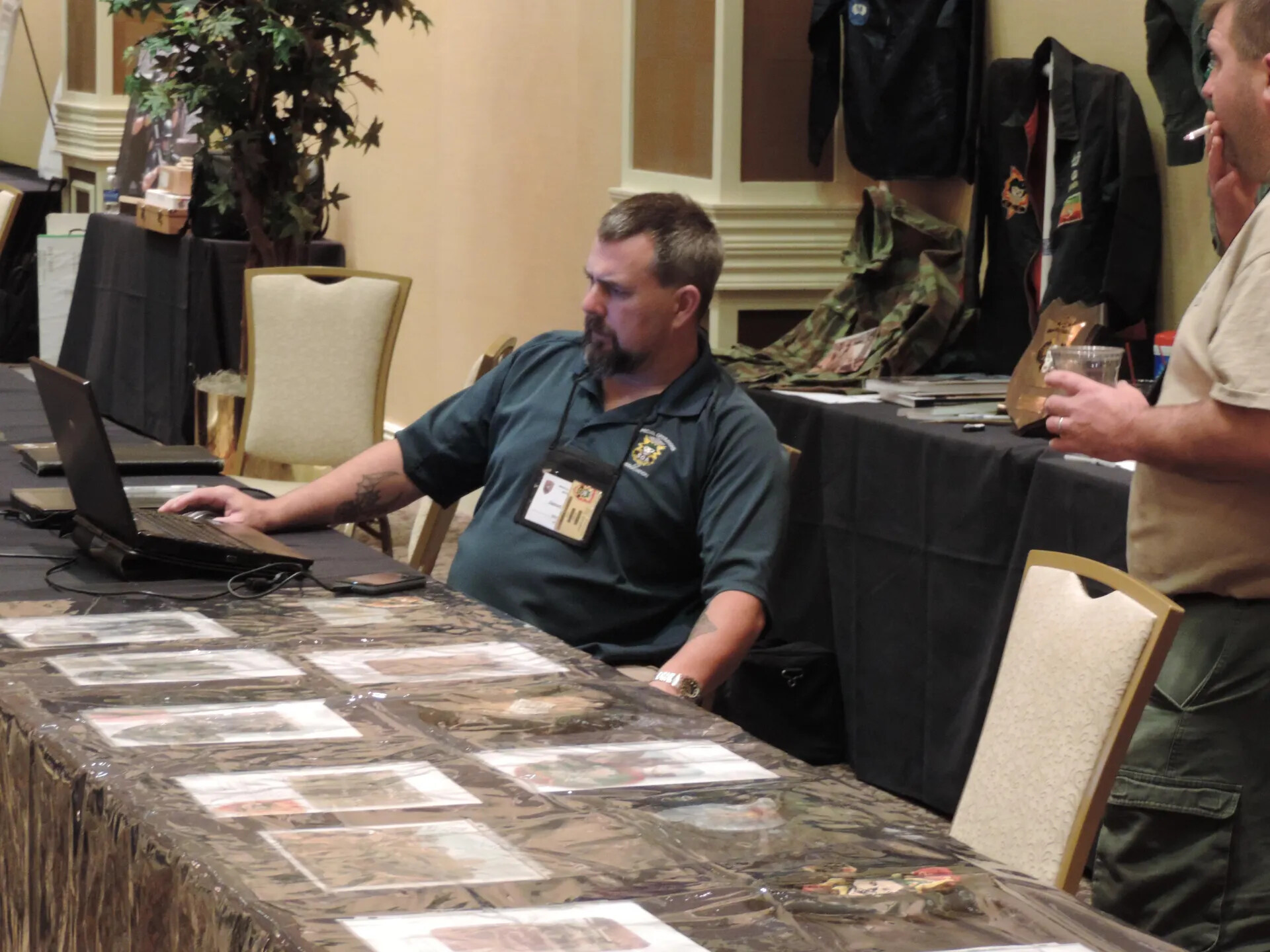Militaria Vendor at His Display Table with Insignia and Photographs, Special Operations Association Reunion, Las Vegas, 2013