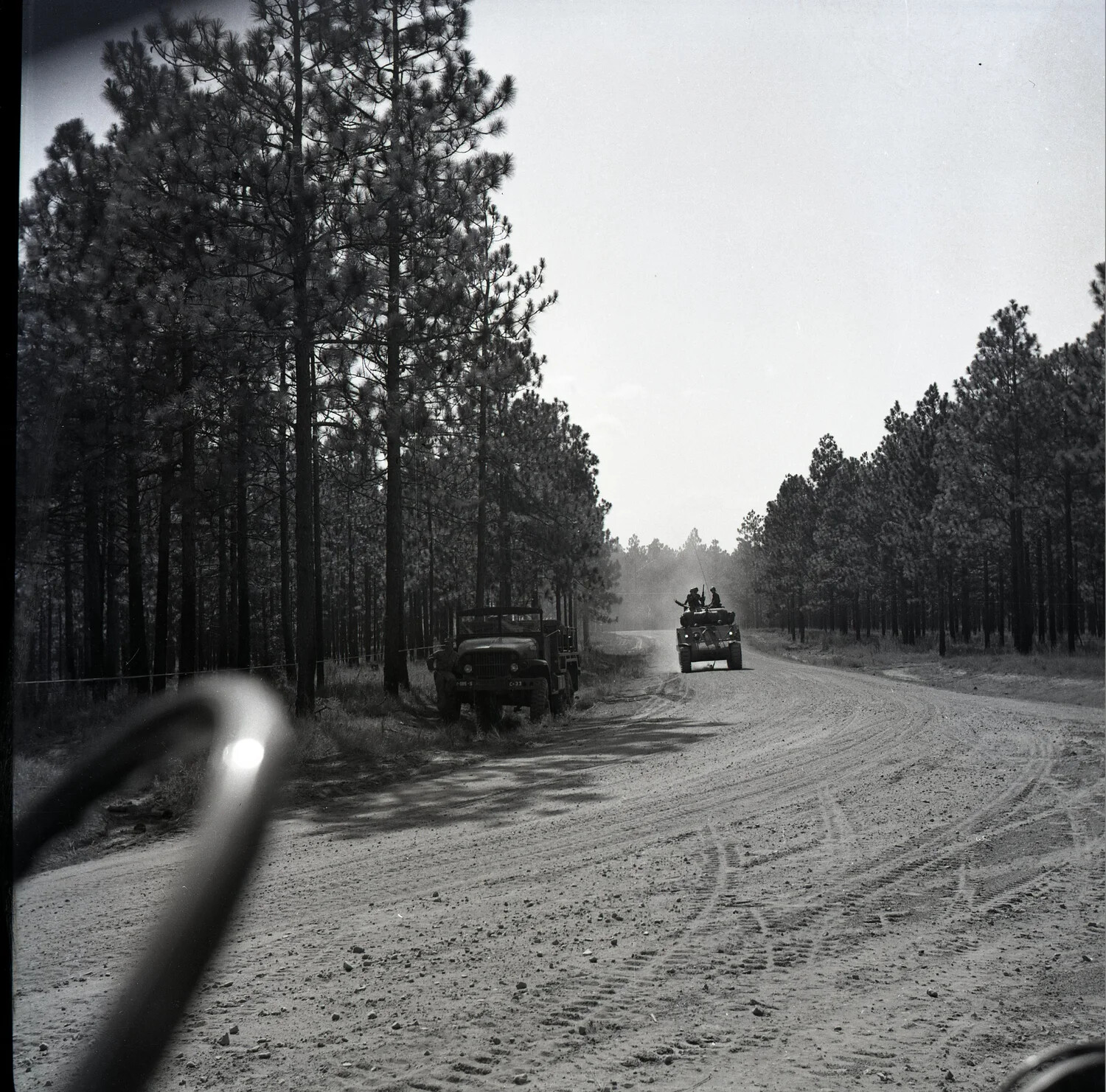 U.S. Army Convoy on Dirt Road During Field Training Exercise, Pine Forest