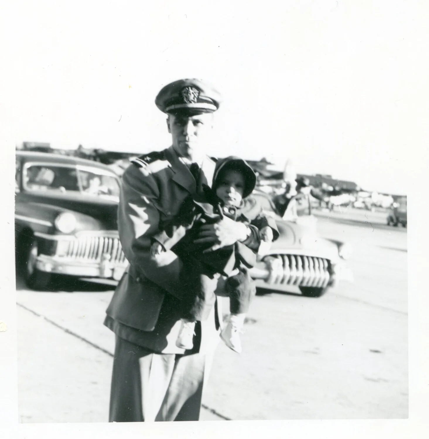 U.S. Navy Officer Holding a Child, Naval Air Station, Early 1950s