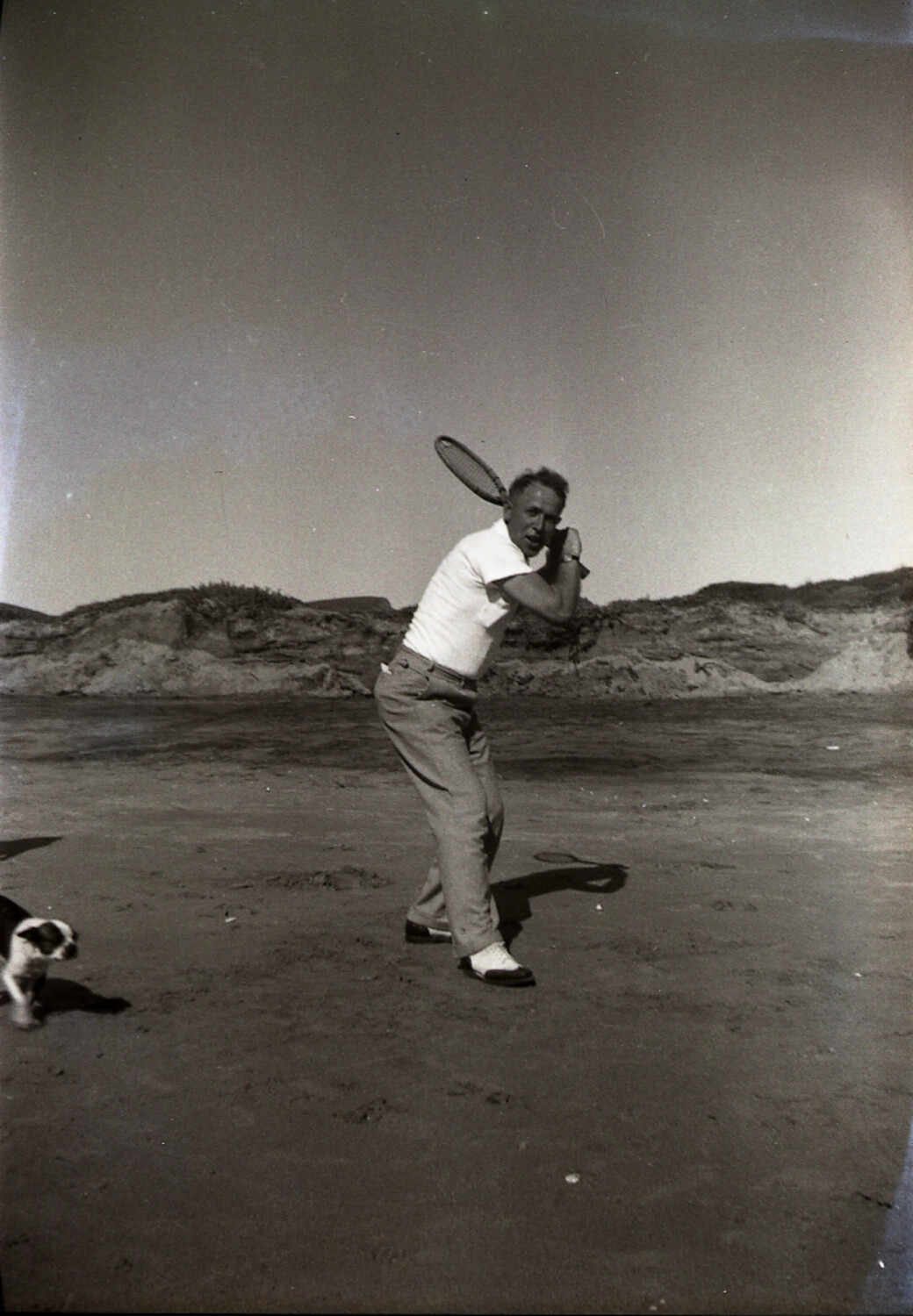 Man Playing Beach Racket Sport with Dog, China Coast, 1930s