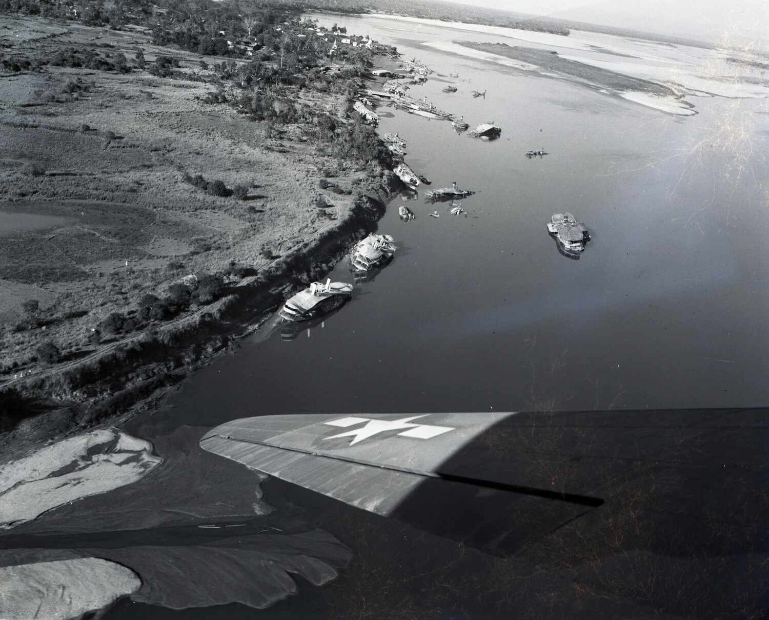 Aerial View of Damaged River Craft Along a Burmese Riverbank -- CBI Theater, WWII