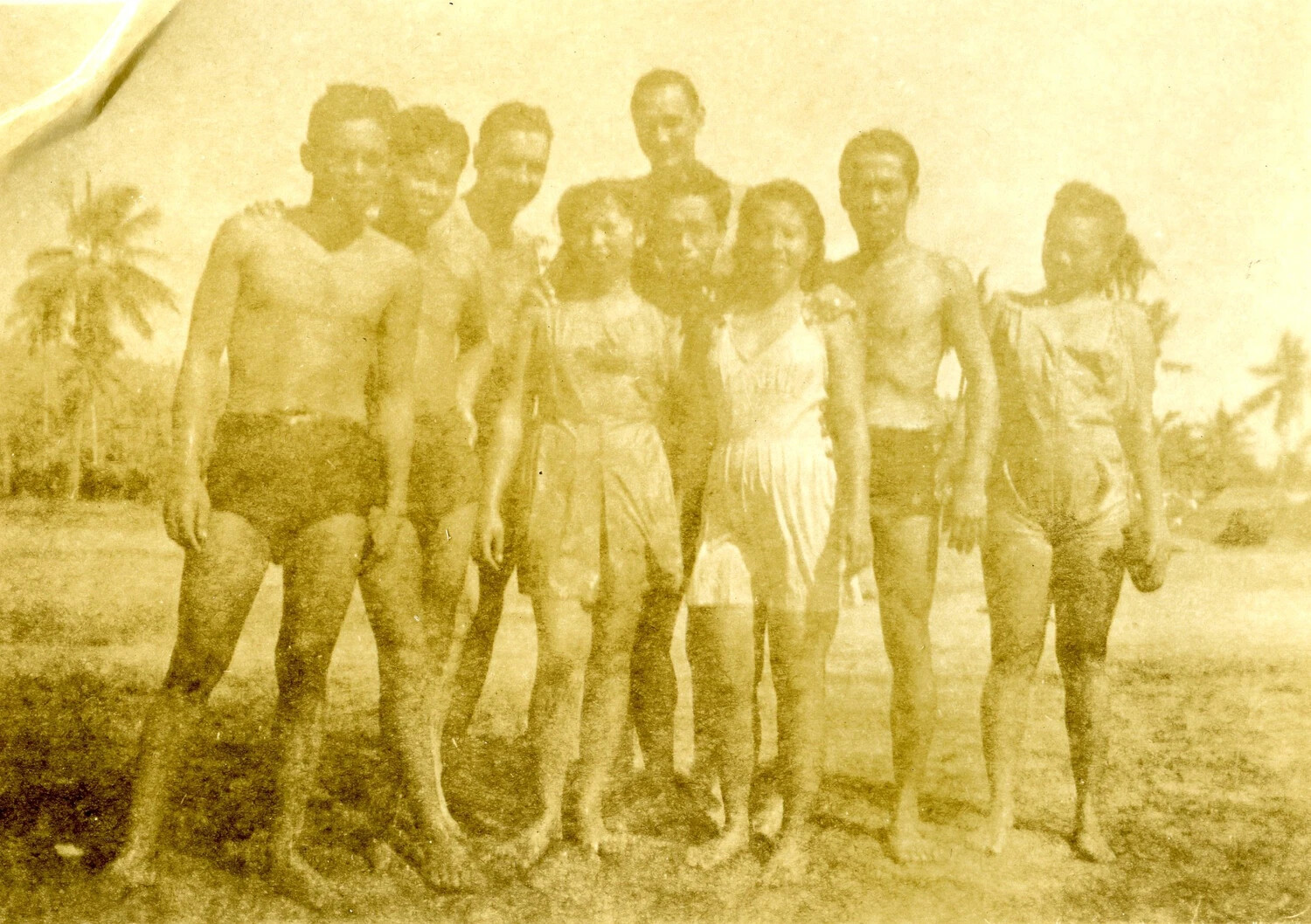 Mixed Group Portrait of Servicemen and Local Women on Beach, Pacific Theater, WWII Era