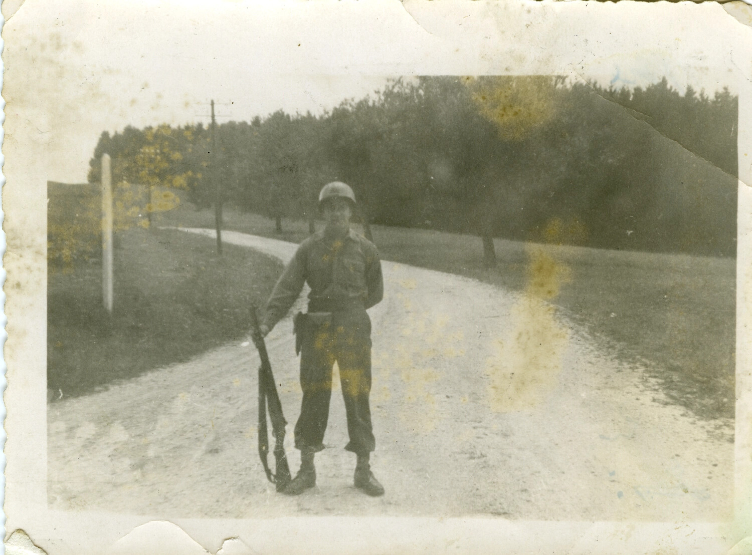 American Soldier Posing with Rifle on Rural Road, European Theater, WWII