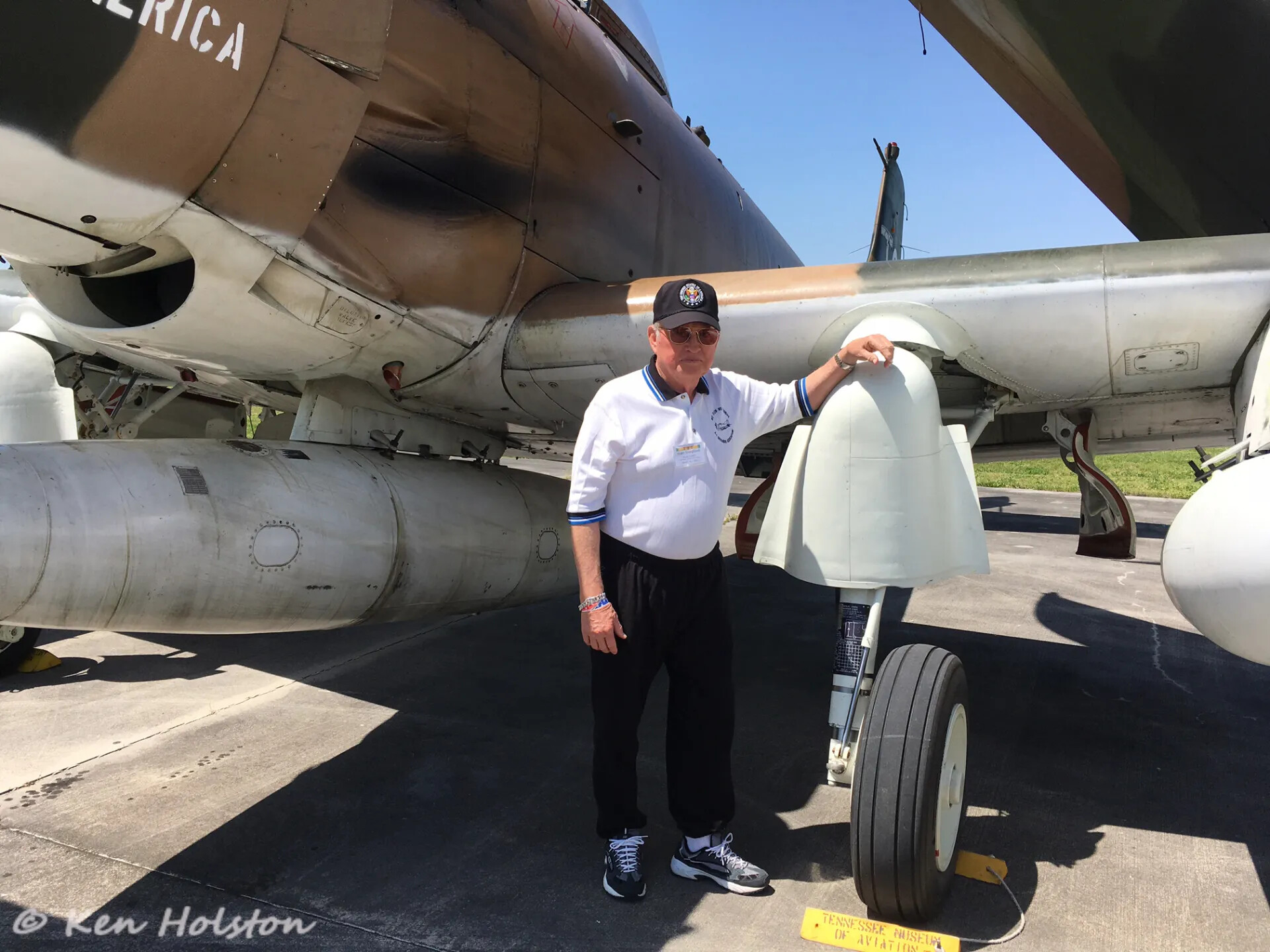 Veteran Poses Beneath A-1 Skyraider 'America' at Tennessee Museum of Aviation