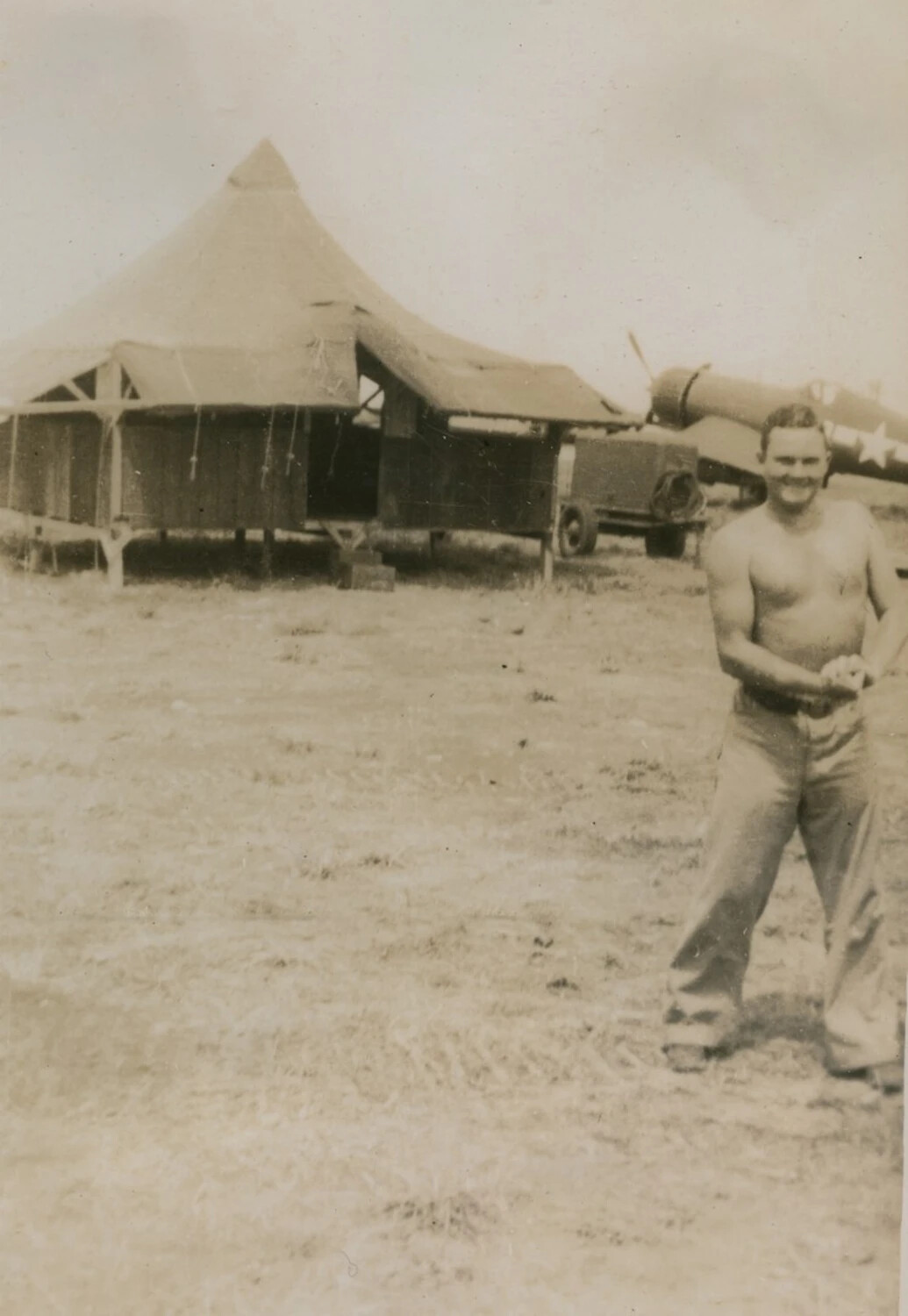 Marine at Tent Camp with Corsair Fighter in Background, Pacific Theater, WWII