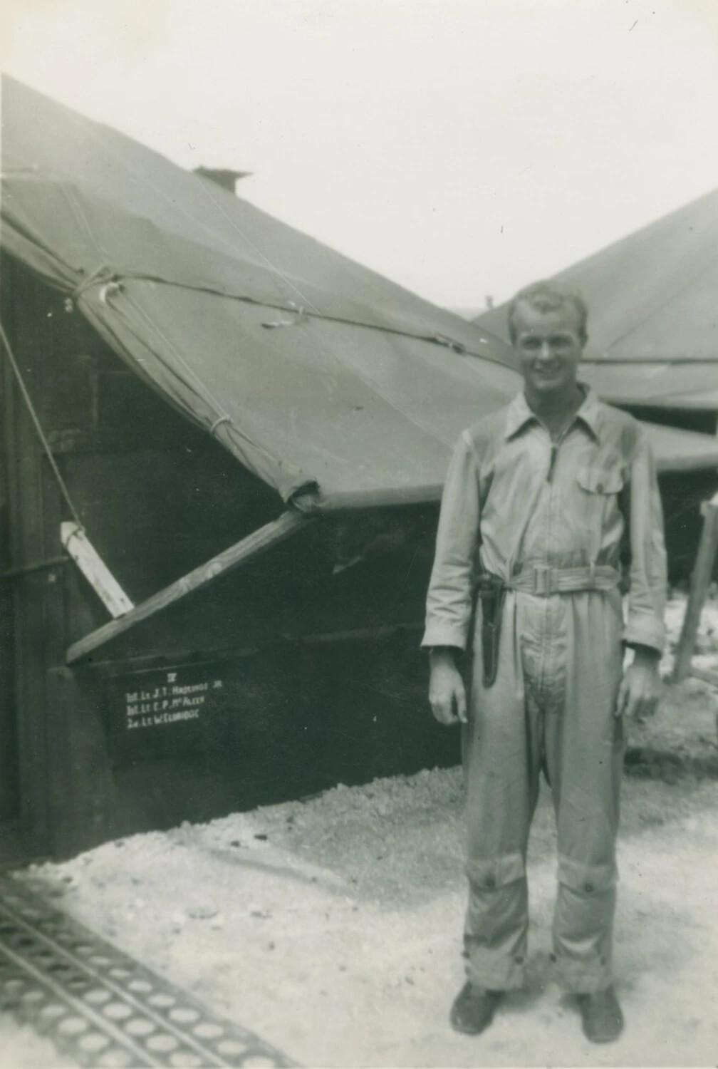 Unidentified Aviator in Flight Coveralls Outside Squad Tent, McAleer Collection