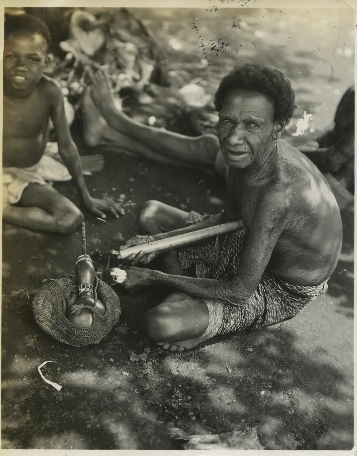 Local Islander Man with Bamboo Implements and Woven Bag, Southwest Pacific Area, World War II Era
