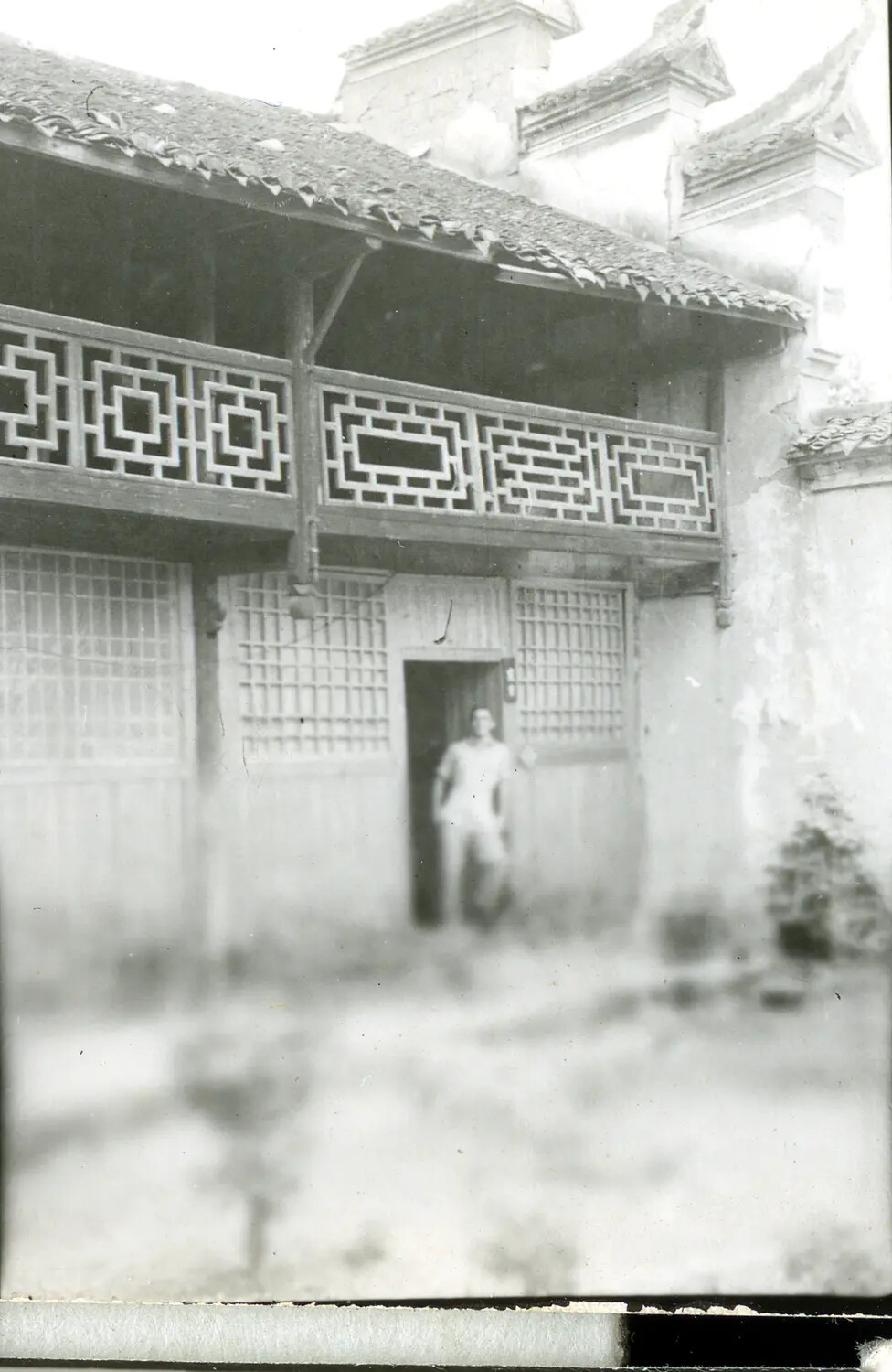 Serviceman at Traditional Building with Latticed Balcony -- China-Burma Theater, WWII