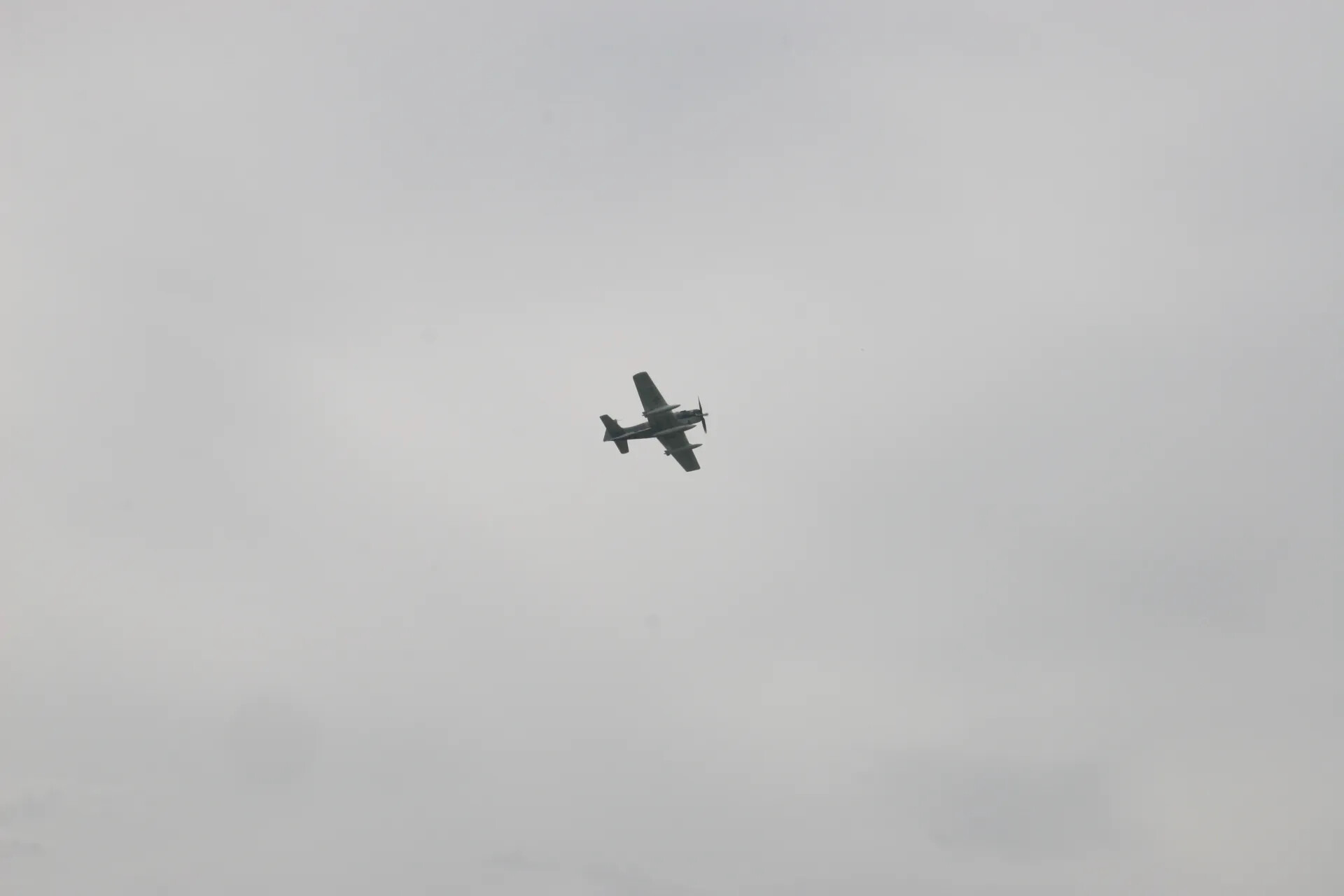 Aircraft Flyby Silhouette Against Overcast Sky, Banking Turn