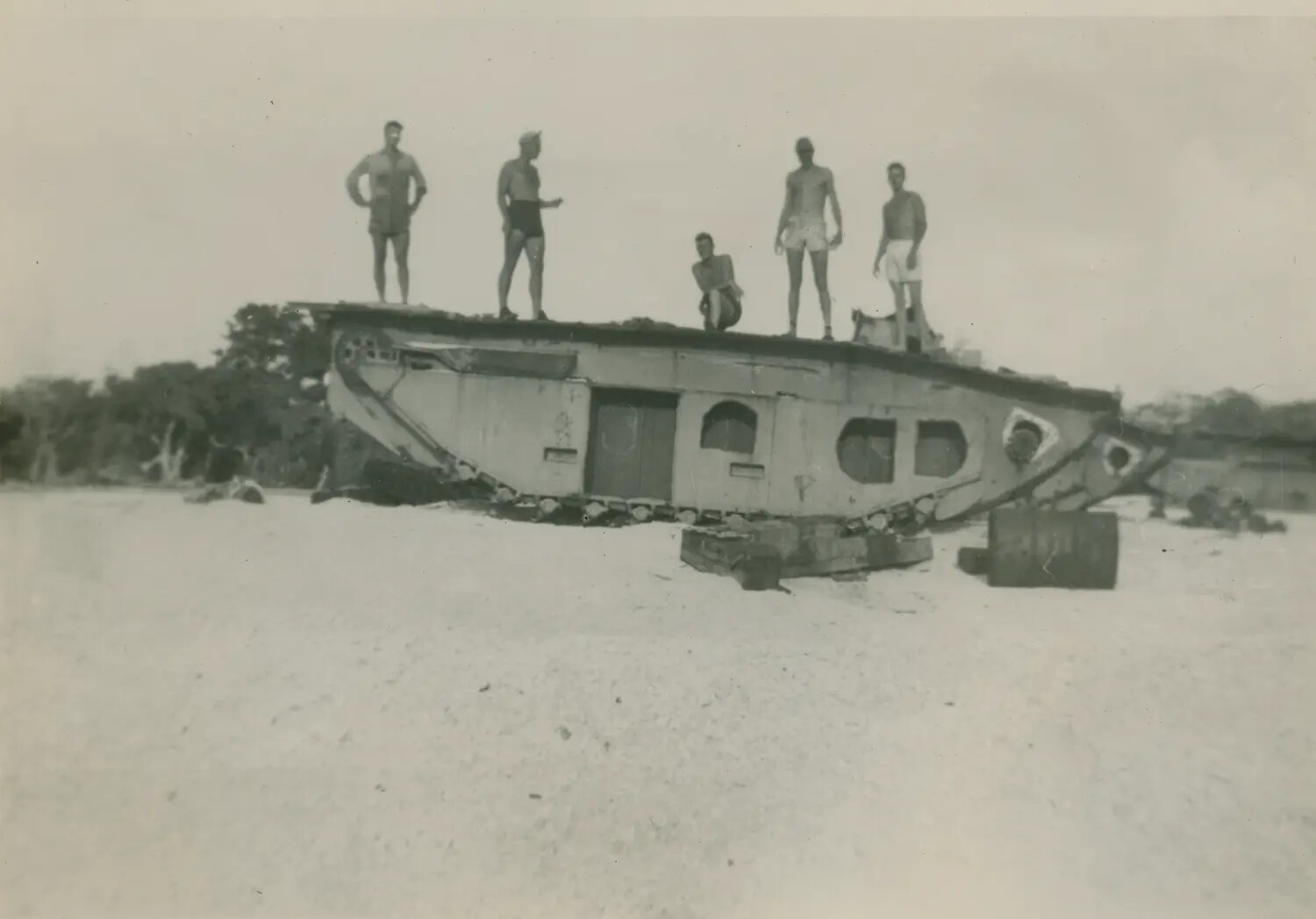 Servicemen Posing on Wrecked Amphibious Tractor (LVT), Pacific Beach, WWII