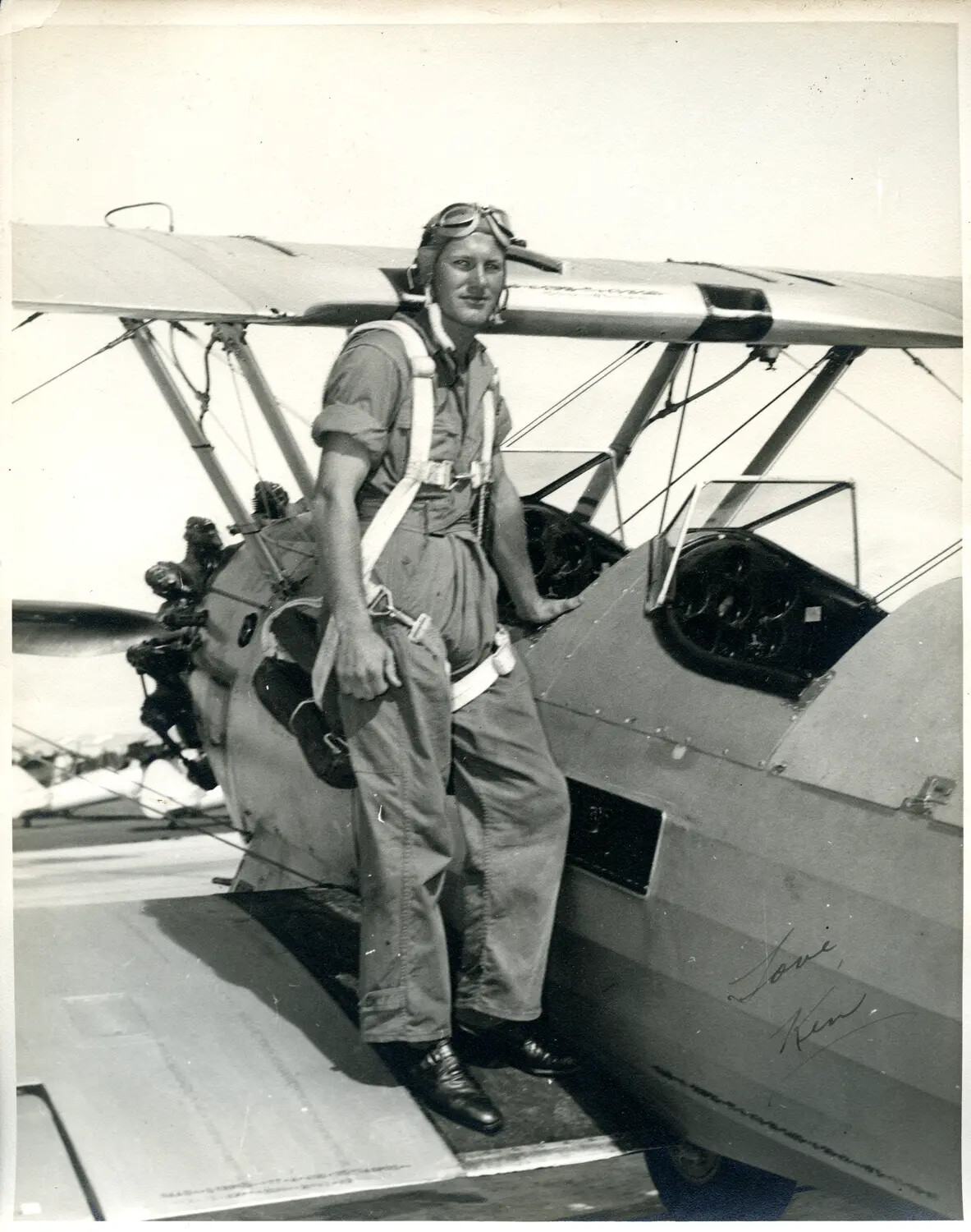 Aviation Cadet Standing on Wing of Stearman-Type Biplane Trainer, WWII Era